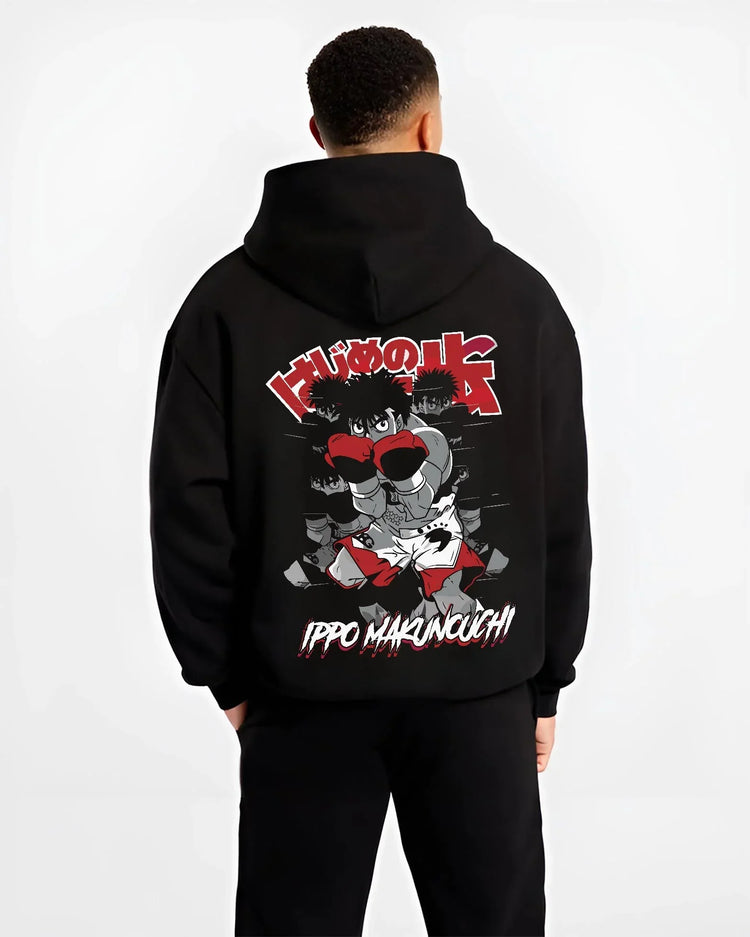 Black hoodie worn by male model, back view with Hajime no Ippo Hoodie Ippo Makunouchi Determined Jumper graphic bold anime graphic.