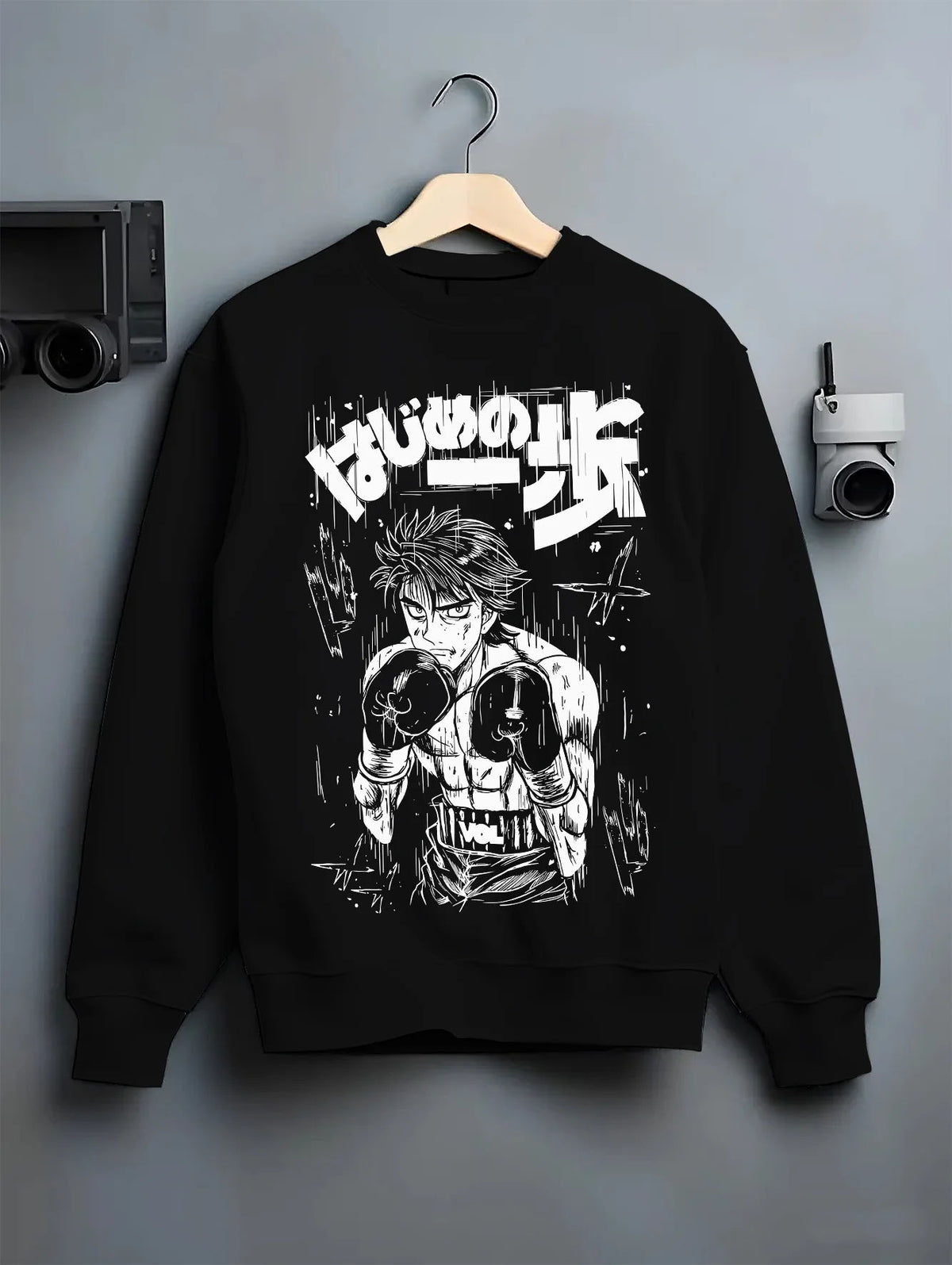 Black crewneck sweatshirt on hanger showing Ippo Makunouchi from Hajime no Ippo: boxing stance monochrome illustration
