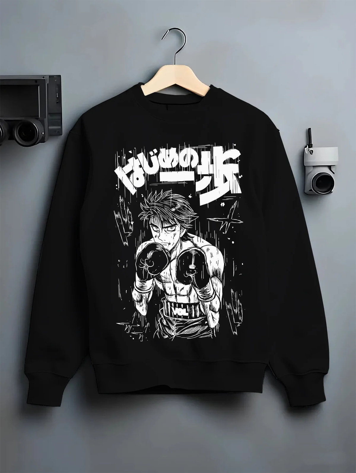 Black crewneck sweatshirt on hanger showing Ippo Makunouchi from Hajime no Ippo: boxing stance monochrome illustration