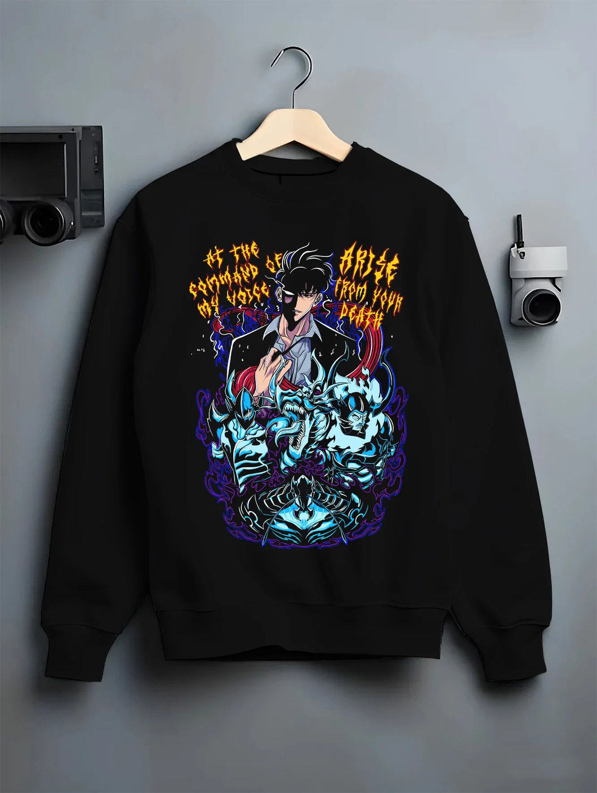 Black crewneck sweatshirt on hanger showing Sung Jin-Woo from Solo Leveling: shadow summons and blue spirits