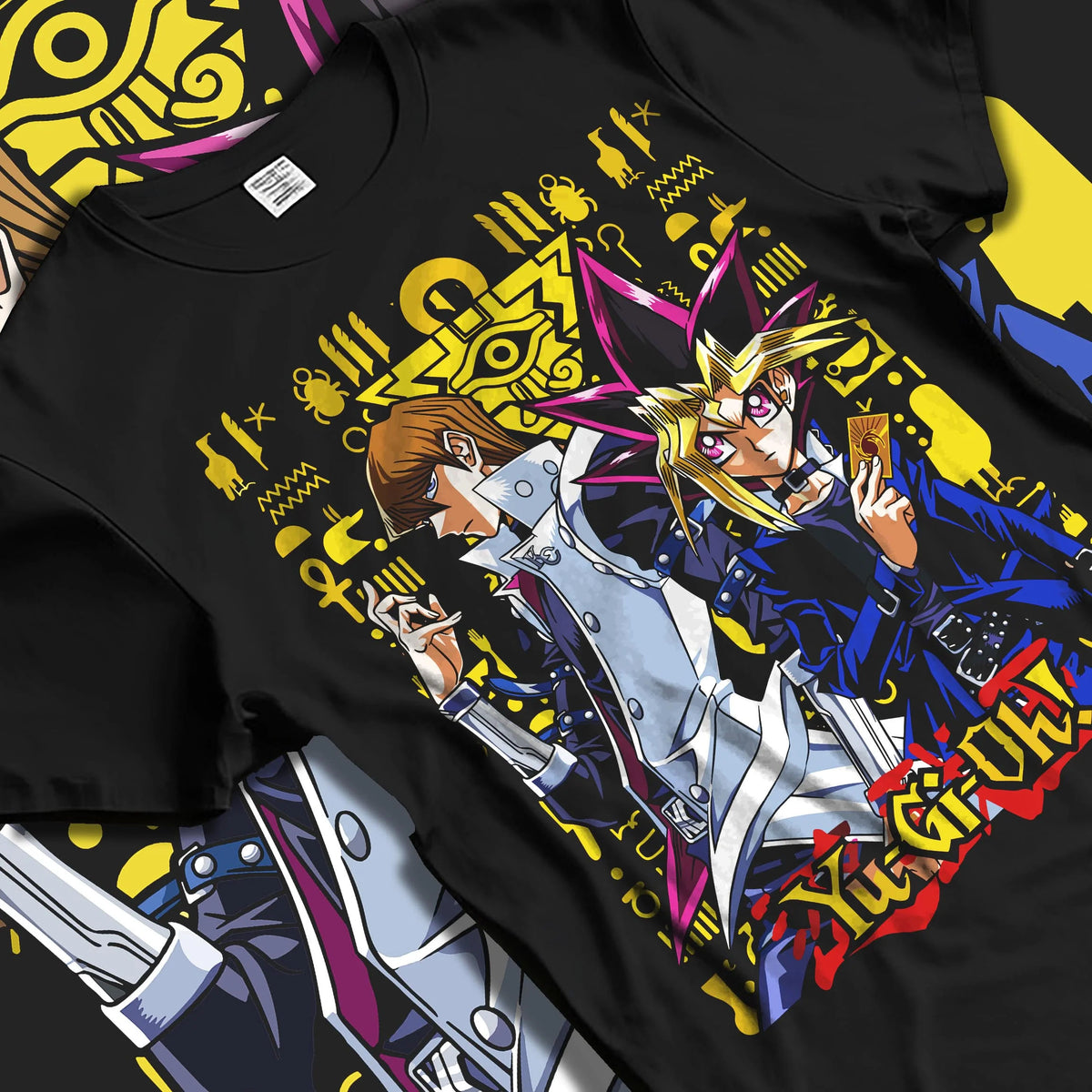 Black T-shirt laid flat with natural folds featuring Yugi and Kaiba duel rivals artwork.