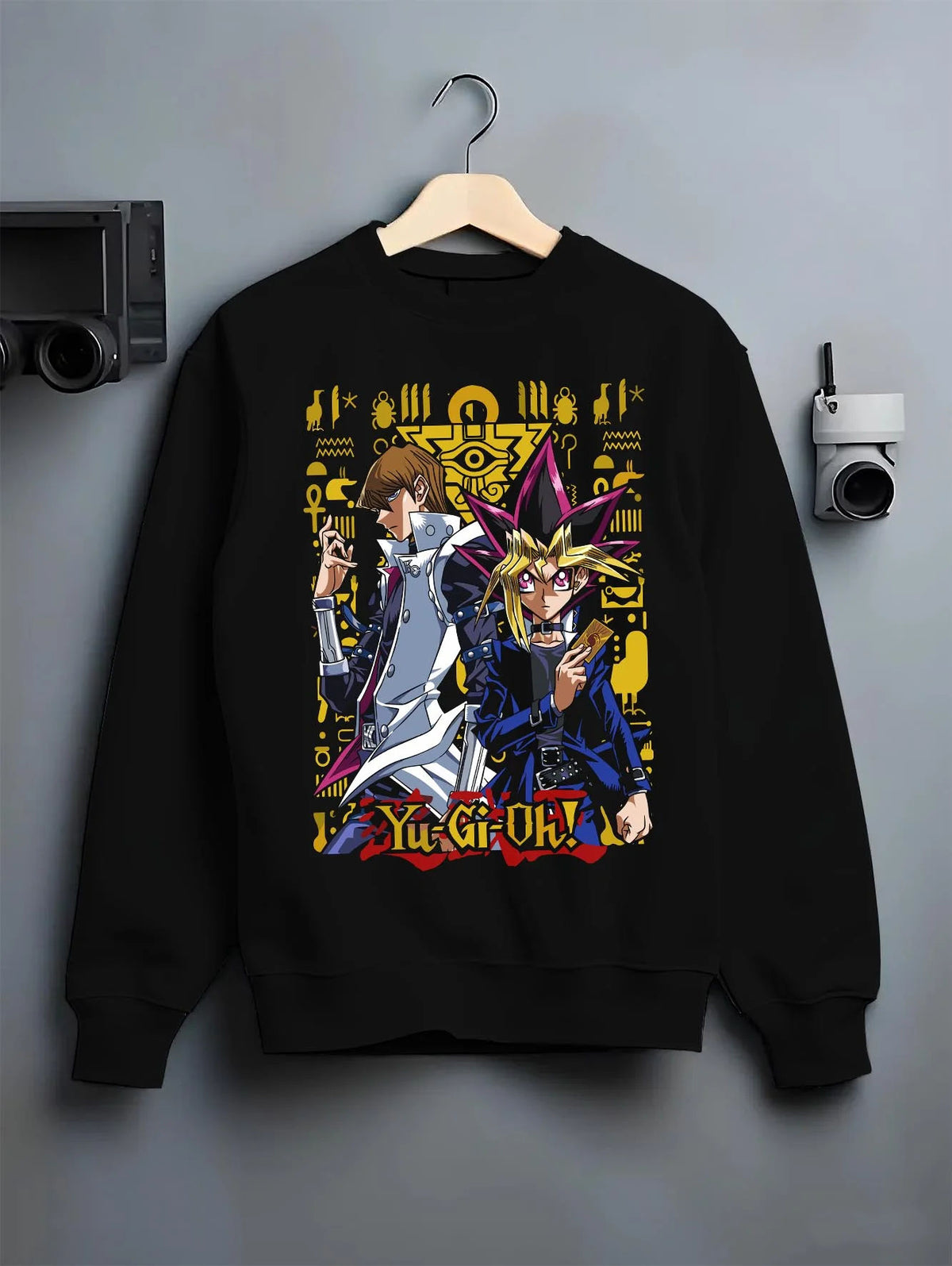 Black crewneck sweatshirt on hanger featuring Yugi and Kaiba duel rivals artwork.