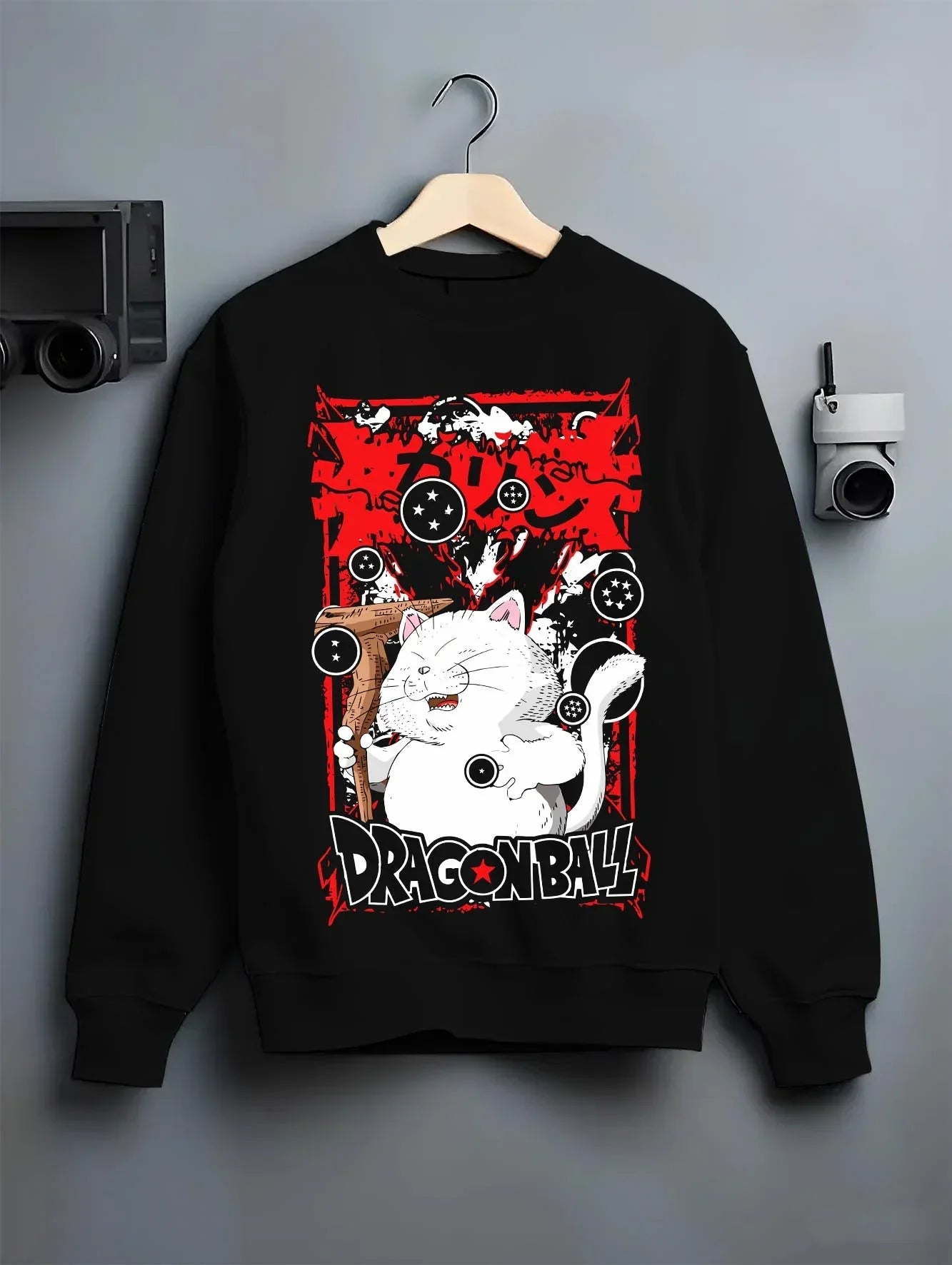 Black crewneck sweatshirt on hanger with Dragon Ball Hoodie Korin Tower Guardian Cat graphic bold anime graphic.