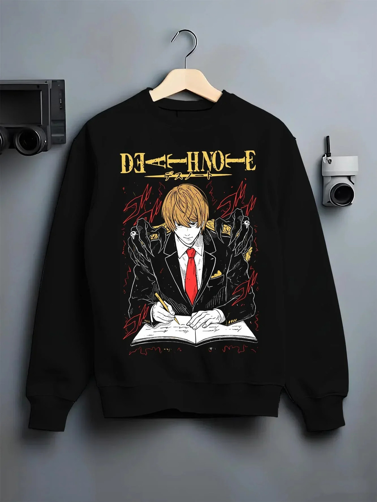 Black crewneck sweatshirt on hanger with Light Yagami Hoodie Death Note Kira Retro Villain graphic streetwear graphic.