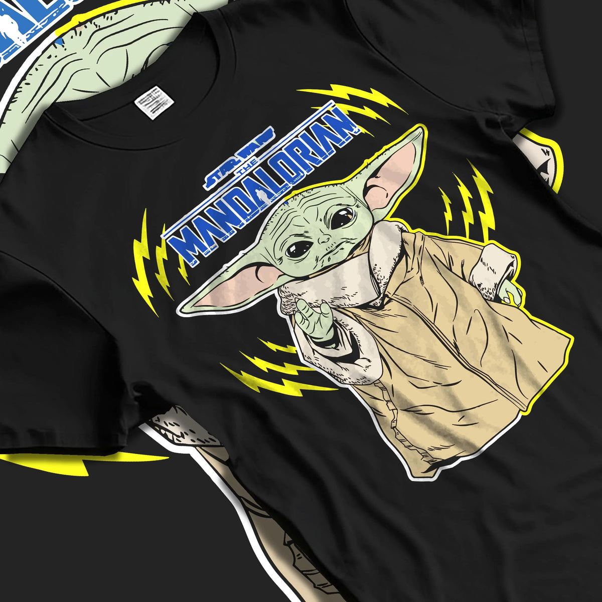 Black T-shirt laid flat with natural folds featuring Grogu from The Mandalorian artwork.