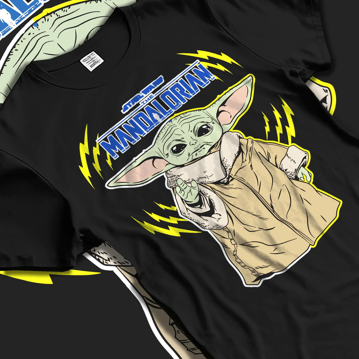 Black T-shirt laid flat with natural folds featuring Grogu from The Mandalorian artwork.