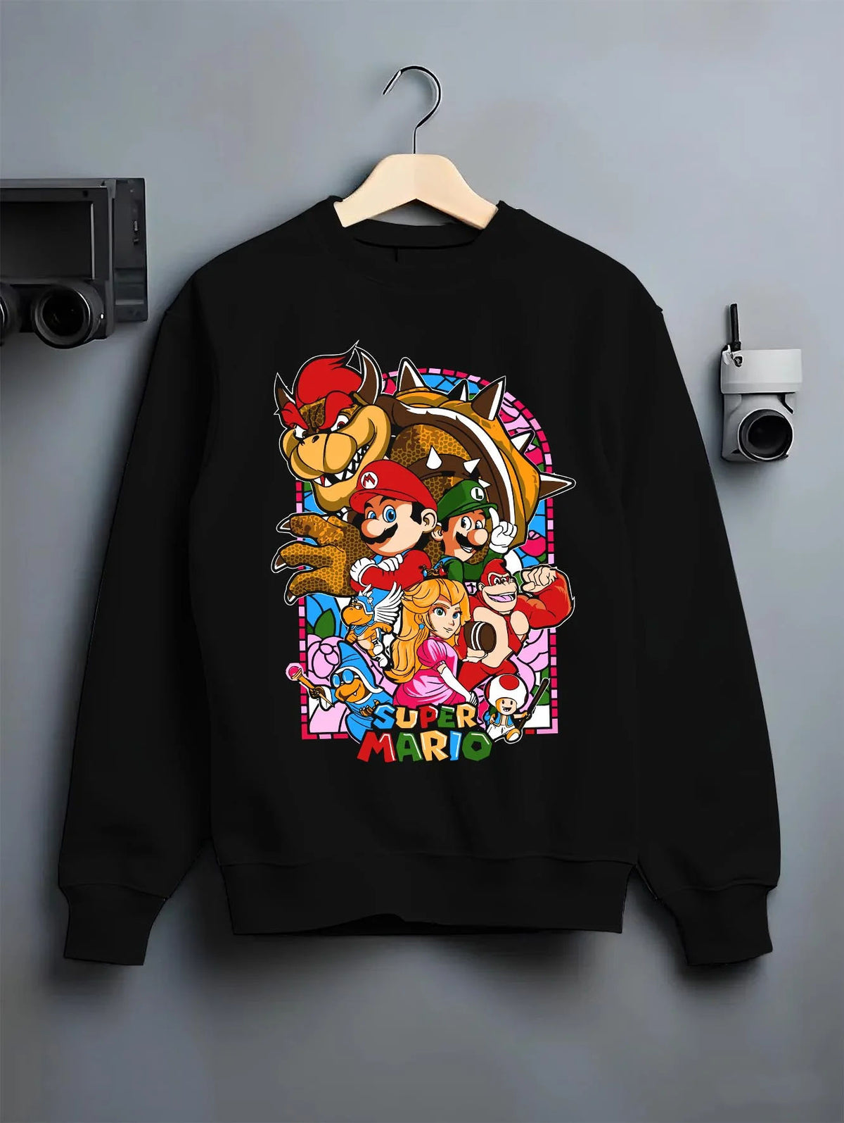Black crewneck sweatshirt on hanger featuring Mario and the Mushroom Kingdom cast artwork.