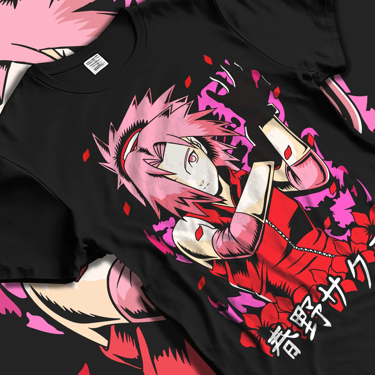 Black T-shirt laid flat with natural folds featuring Sakura Haruno medical ninja strength artwork.
