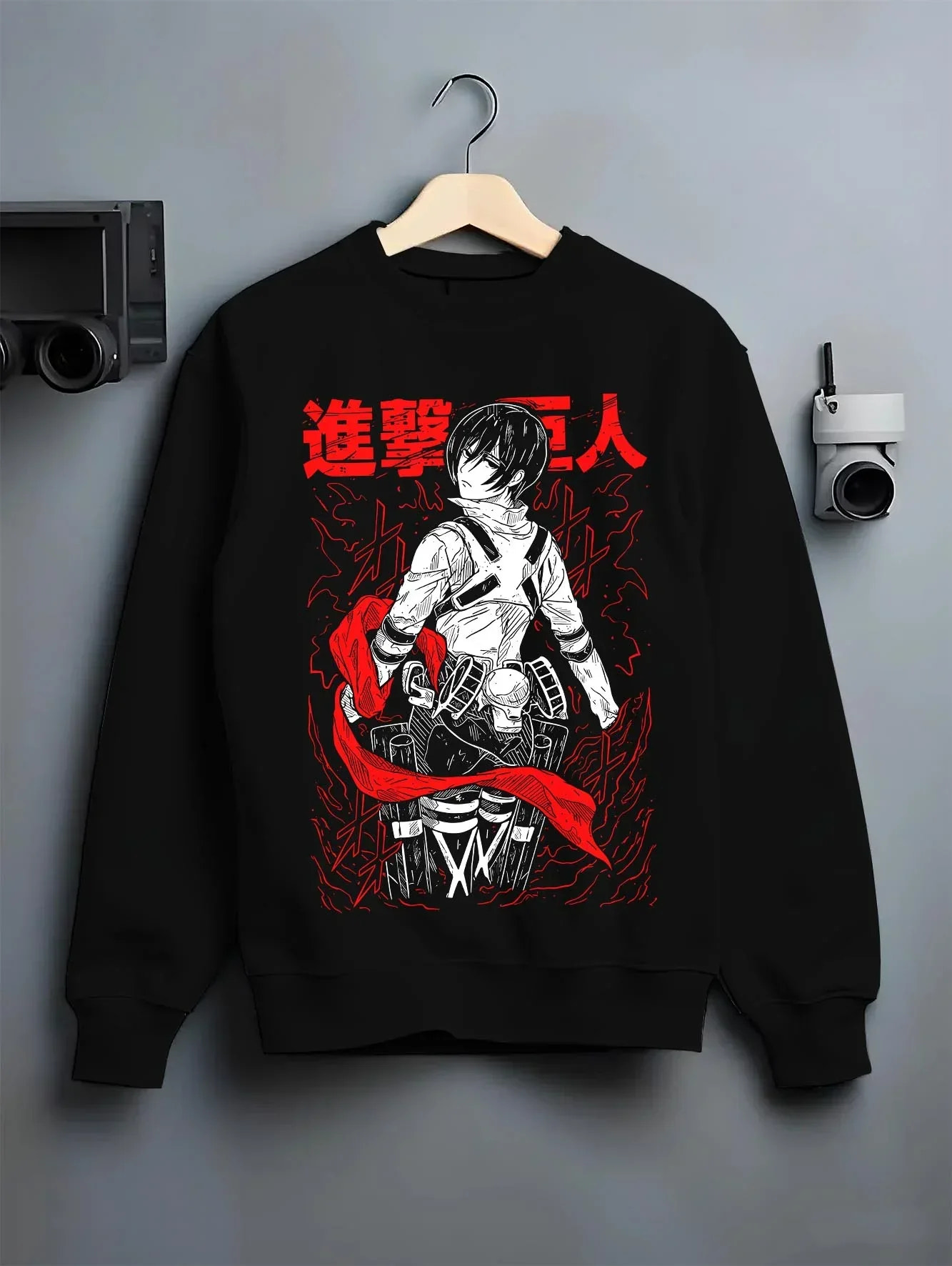 Black crewneck sweatshirt on hanger, showing retro streetwear graphic of Mikasa Ackerman from Attack on Titan.