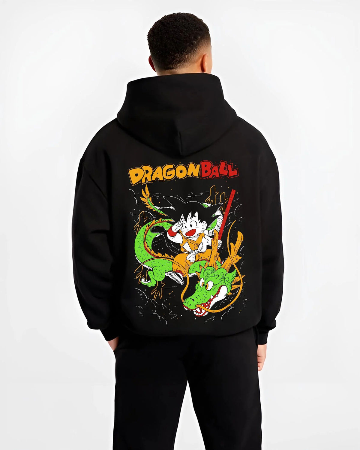 Black hoodie worn by male model from the back featuring Kid Goku and Shenron artwork.