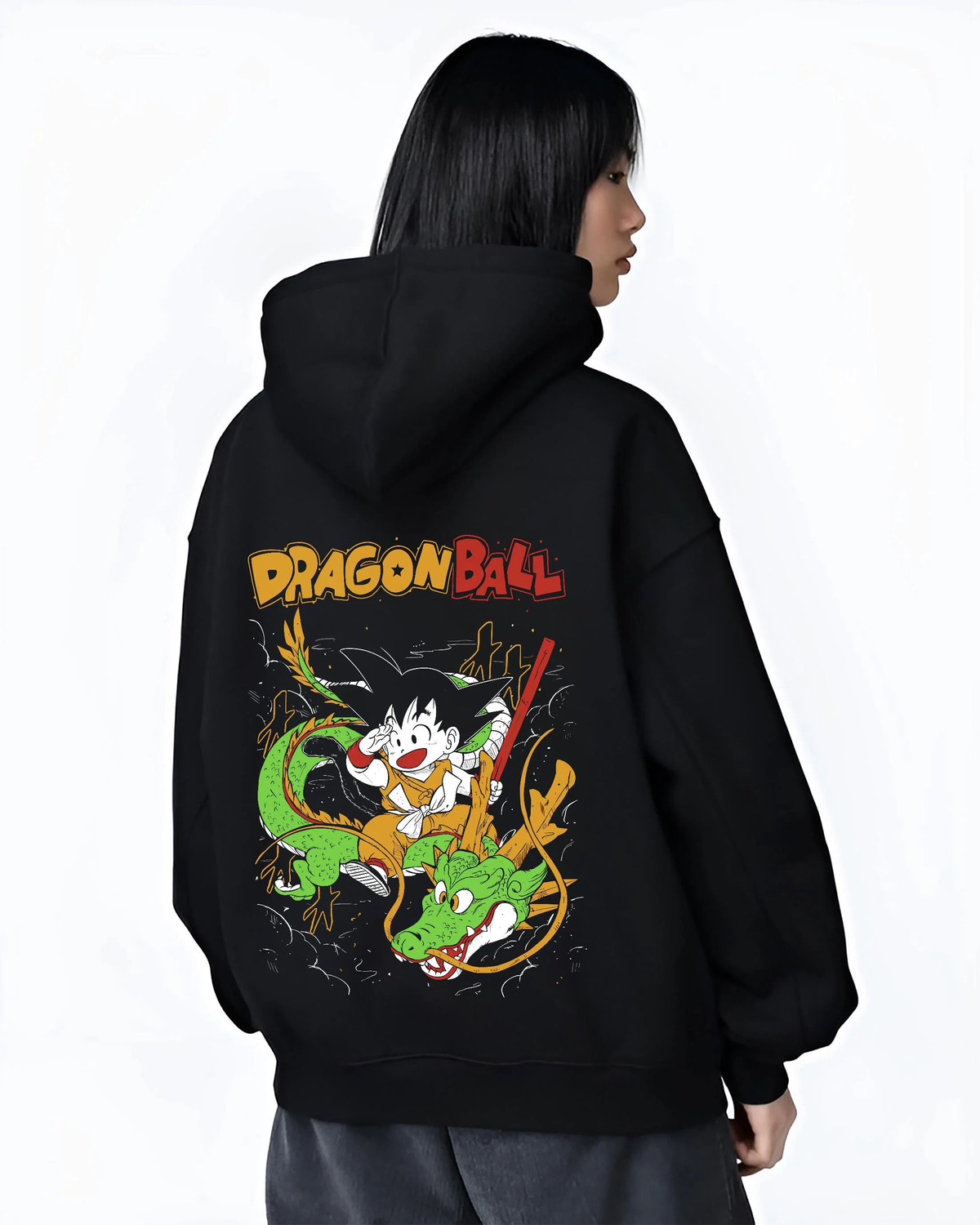 Black hoodie worn by female model from the back featuring Kid Goku and Shenron artwork.