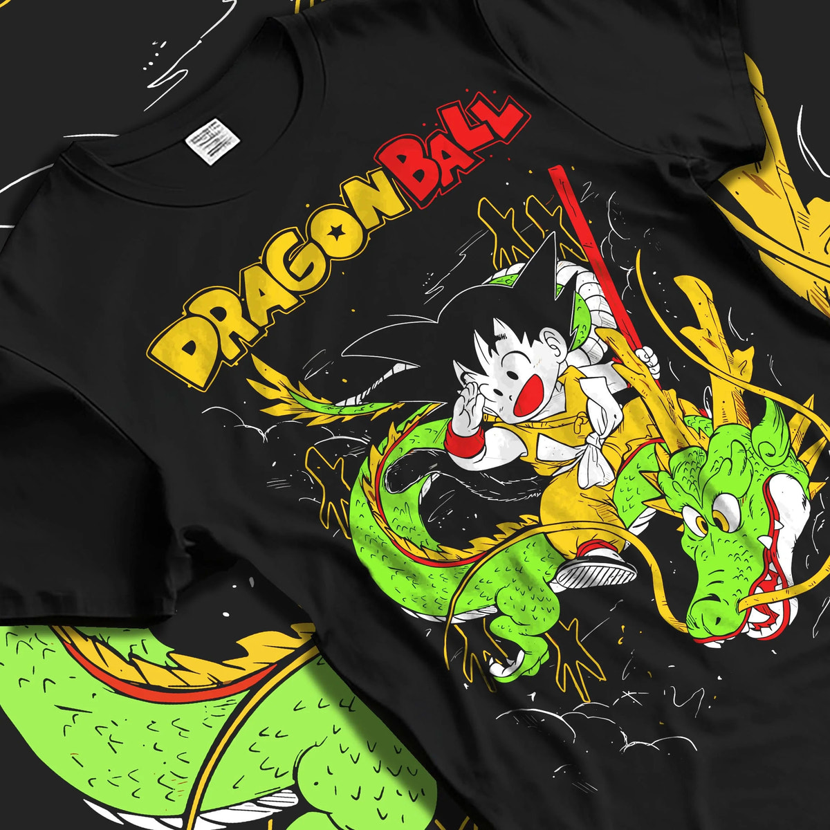 Black T-shirt laid flat with natural folds featuring Kid Goku and Shenron artwork.