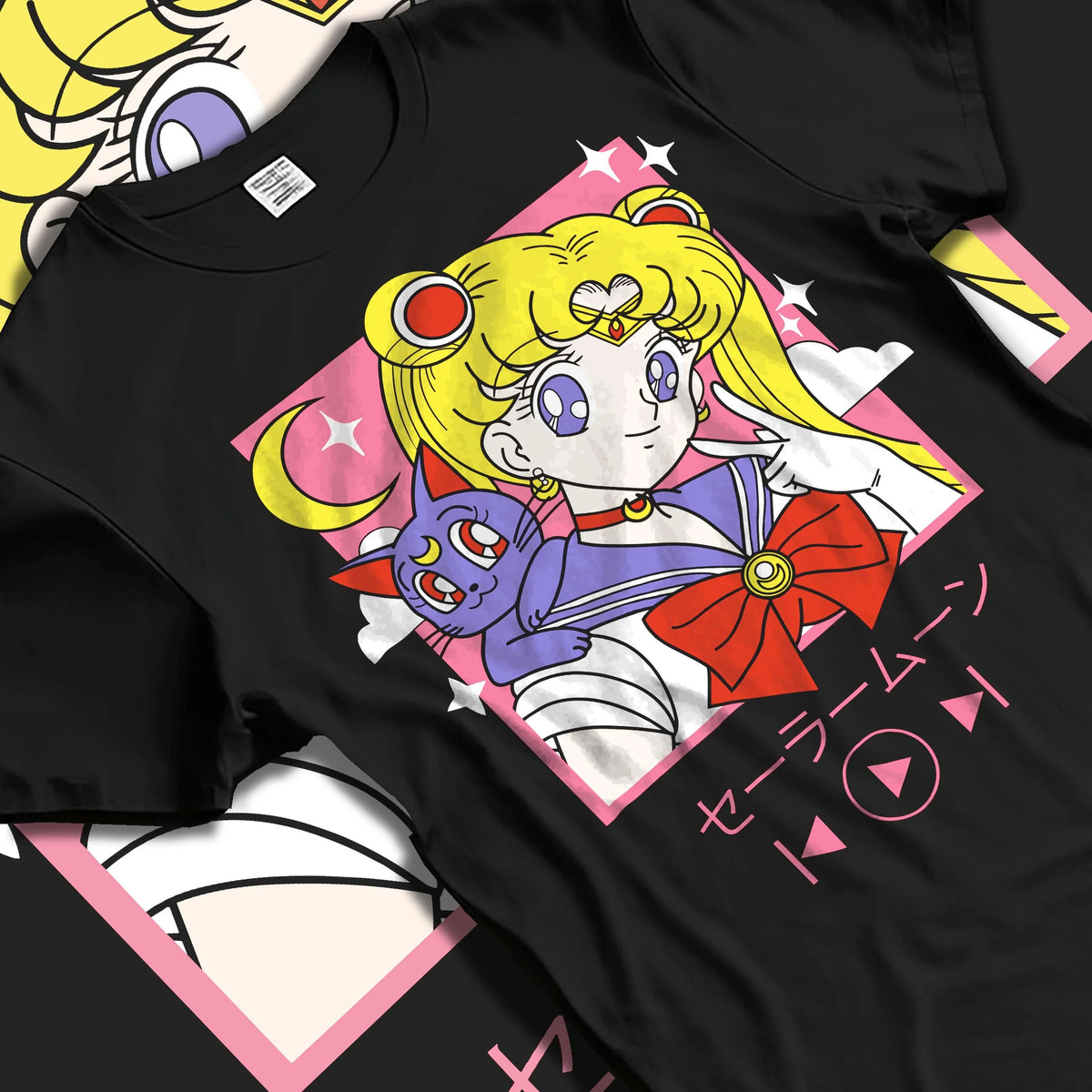 Black T-shirt laid flat with natural folds featuring Sailor Moon with Luna artwork.