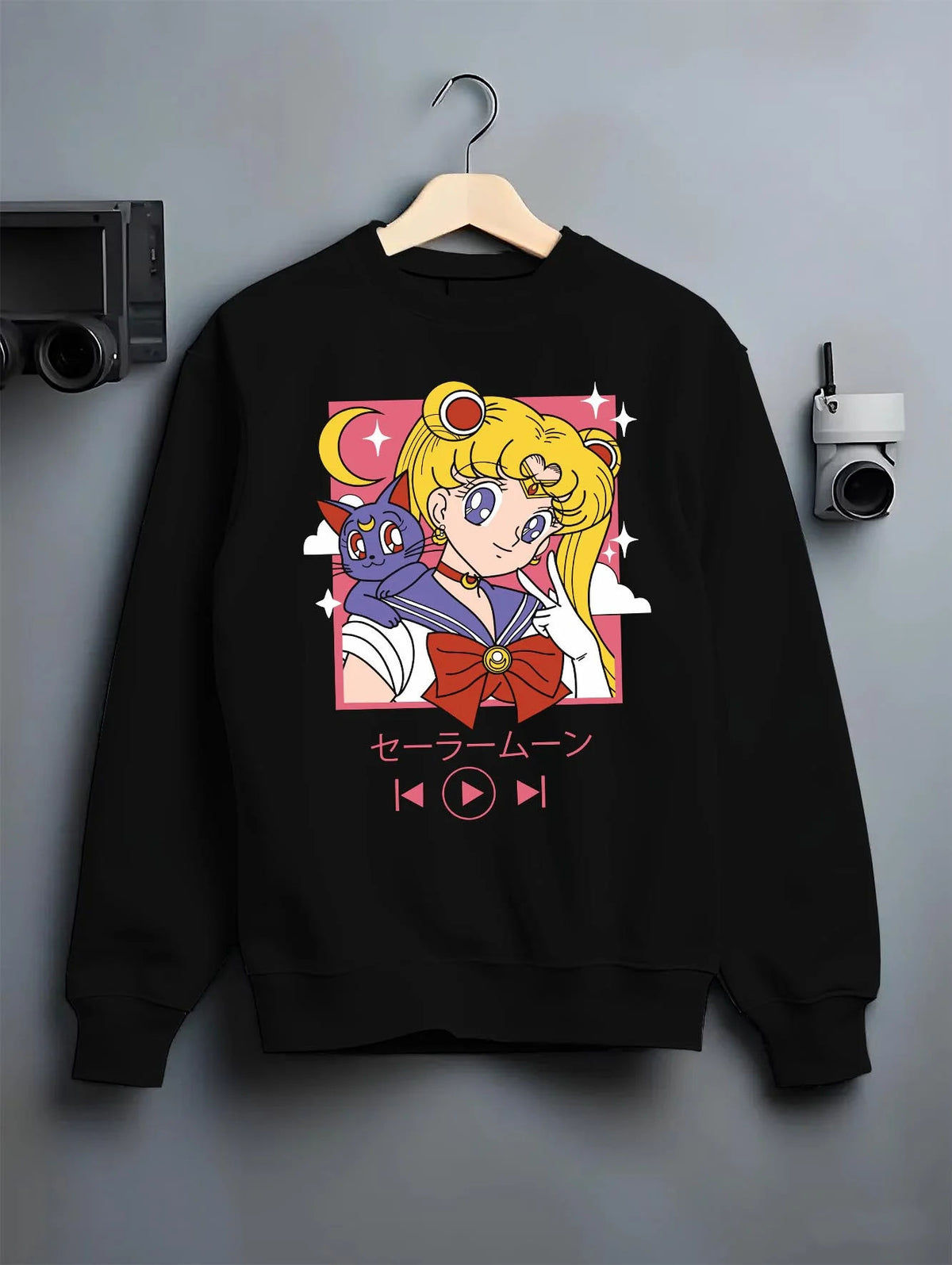 Black crewneck sweatshirt on hanger featuring Sailor Moon with Luna artwork.
