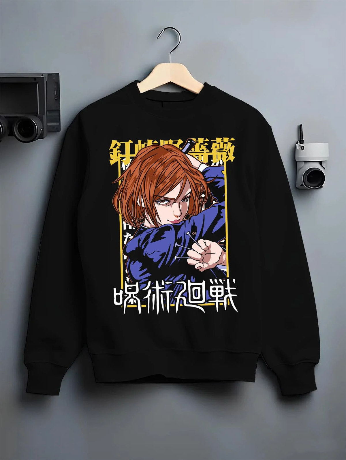 Black crewneck sweatshirt on hanger featuring Nobara Kugisaki hammer and nails artwork.