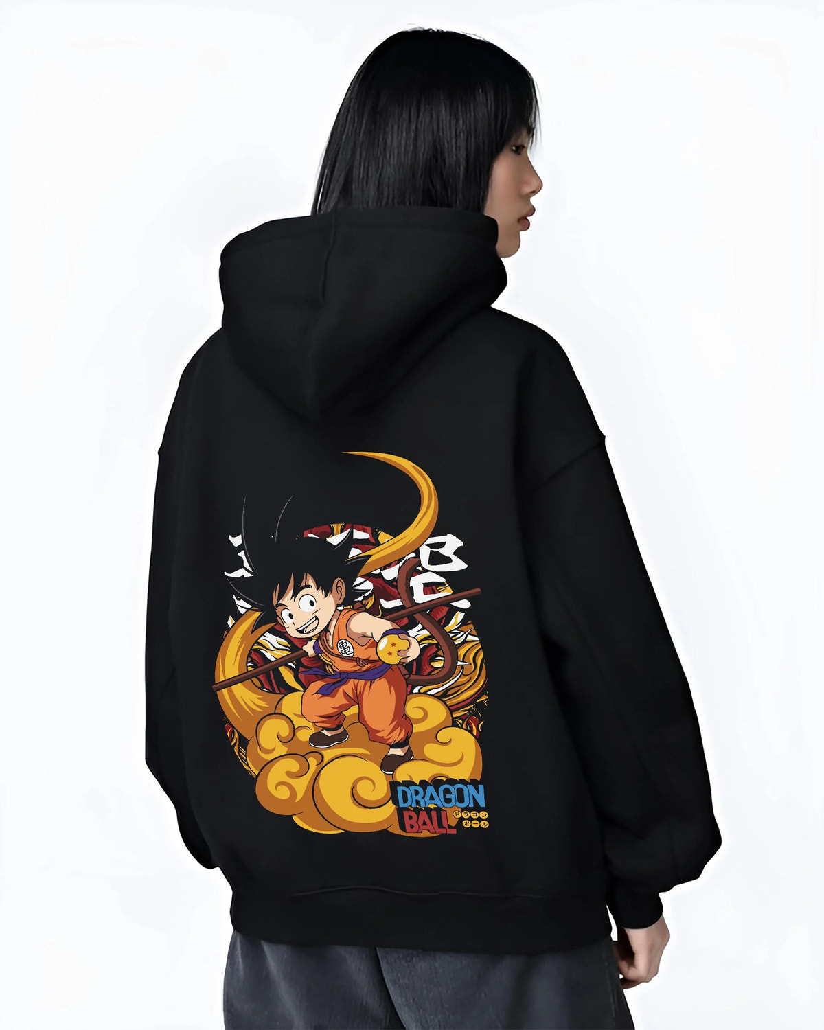 Black hoodie worn by female model from the back featuring Kid Goku riding Flying Nimbus artwork.