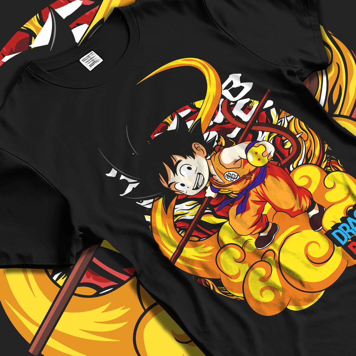 Black T-shirt laid flat with natural folds featuring Kid Goku riding Flying Nimbus artwork.