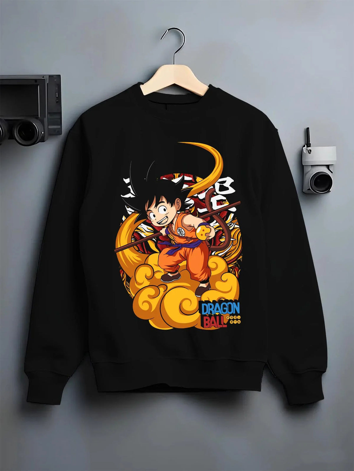 Black crewneck sweatshirt on hanger featuring Kid Goku riding Flying Nimbus artwork.