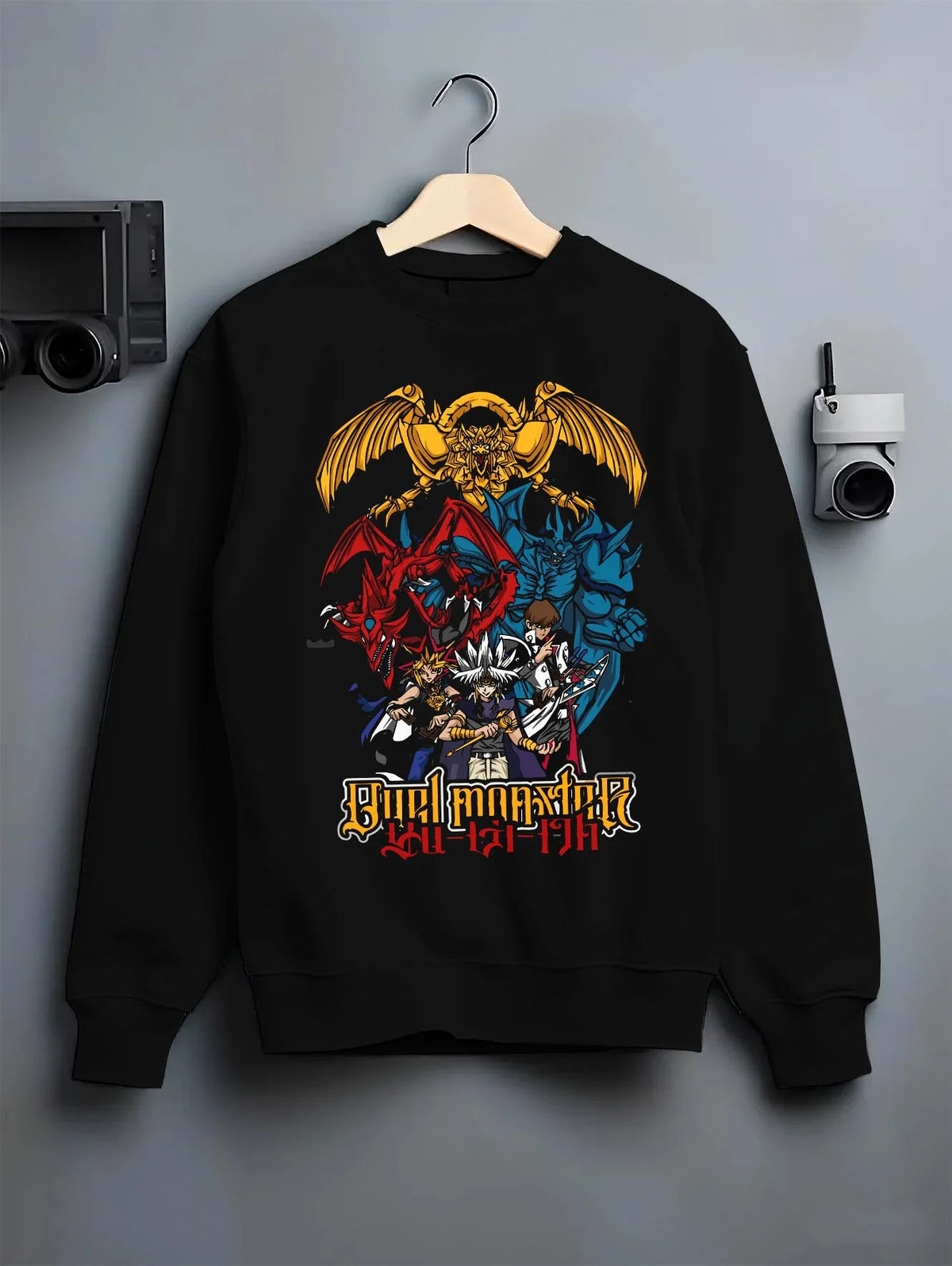 Black crewneck sweatshirt on hanger featuring Obelisk the Tormentor Egyptian God Yu-Gi-Oh! artwork.