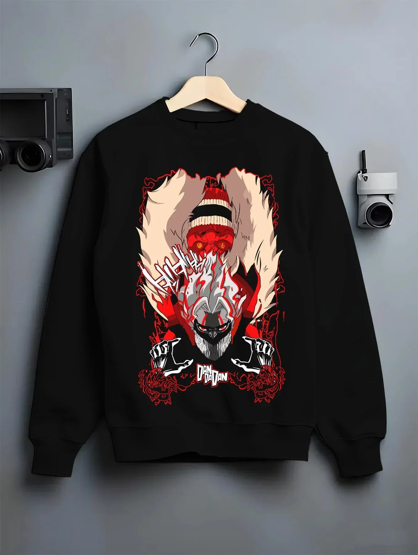 Black crewneck sweatshirt on hanger with Turbo Granny Dandadan Hoodie Retro Yokai Anime Horror graphic bold anime graphic.