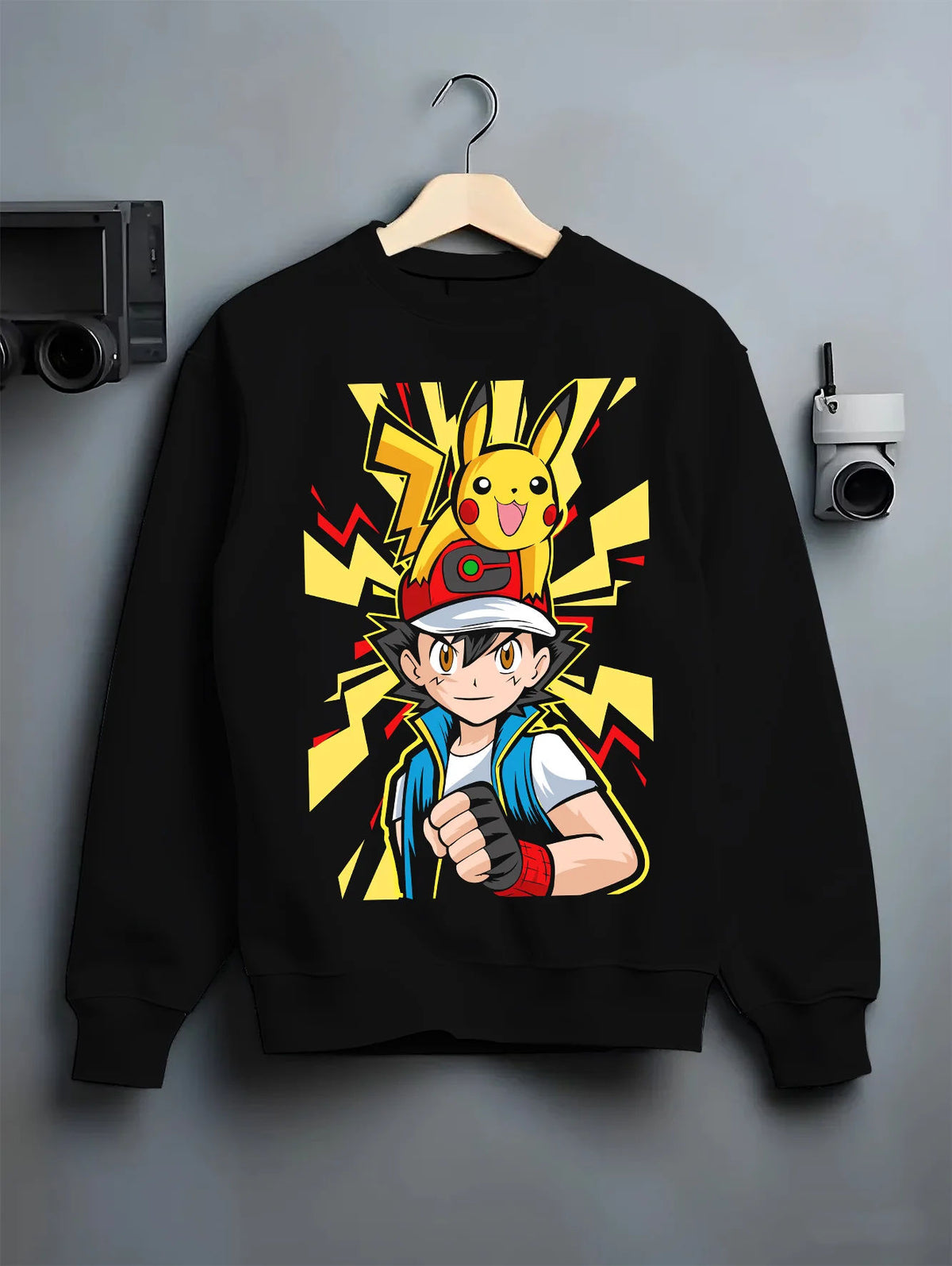 Black crewneck sweatshirt on hanger with Ash / Red with yellow Pikachu lightning design from Pokémon illustrated back graphic