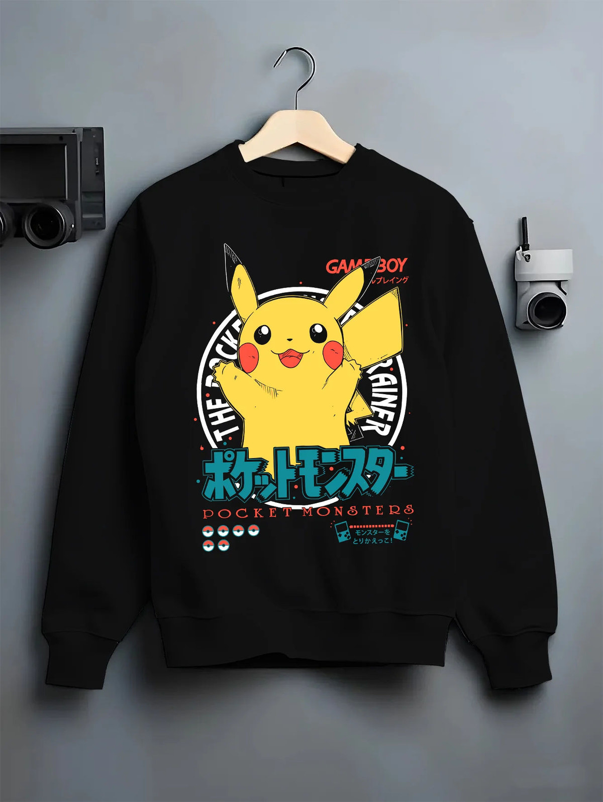 Black crewneck sweatshirt on hanger showing Pikachu from Pokémon: happy Game Boy illustration