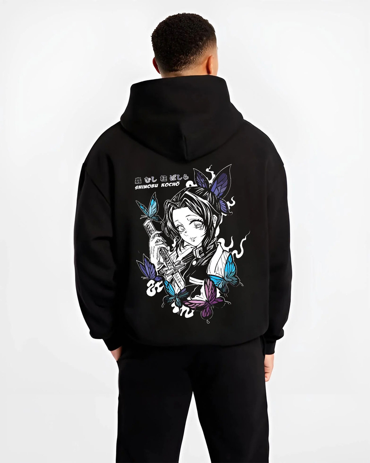Black hoodie worn by male model from the back featuring Shinobu Kocho poison butterfly Demon Slayer artwork.