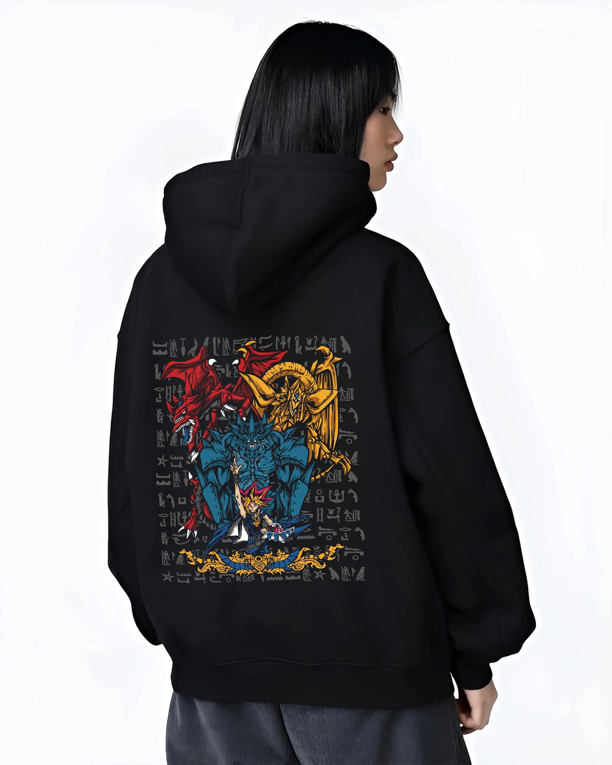 Black hoodie worn by female model from the back featuring Yugi with the Egyptian Gods Yu-Gi-Oh! artwork.