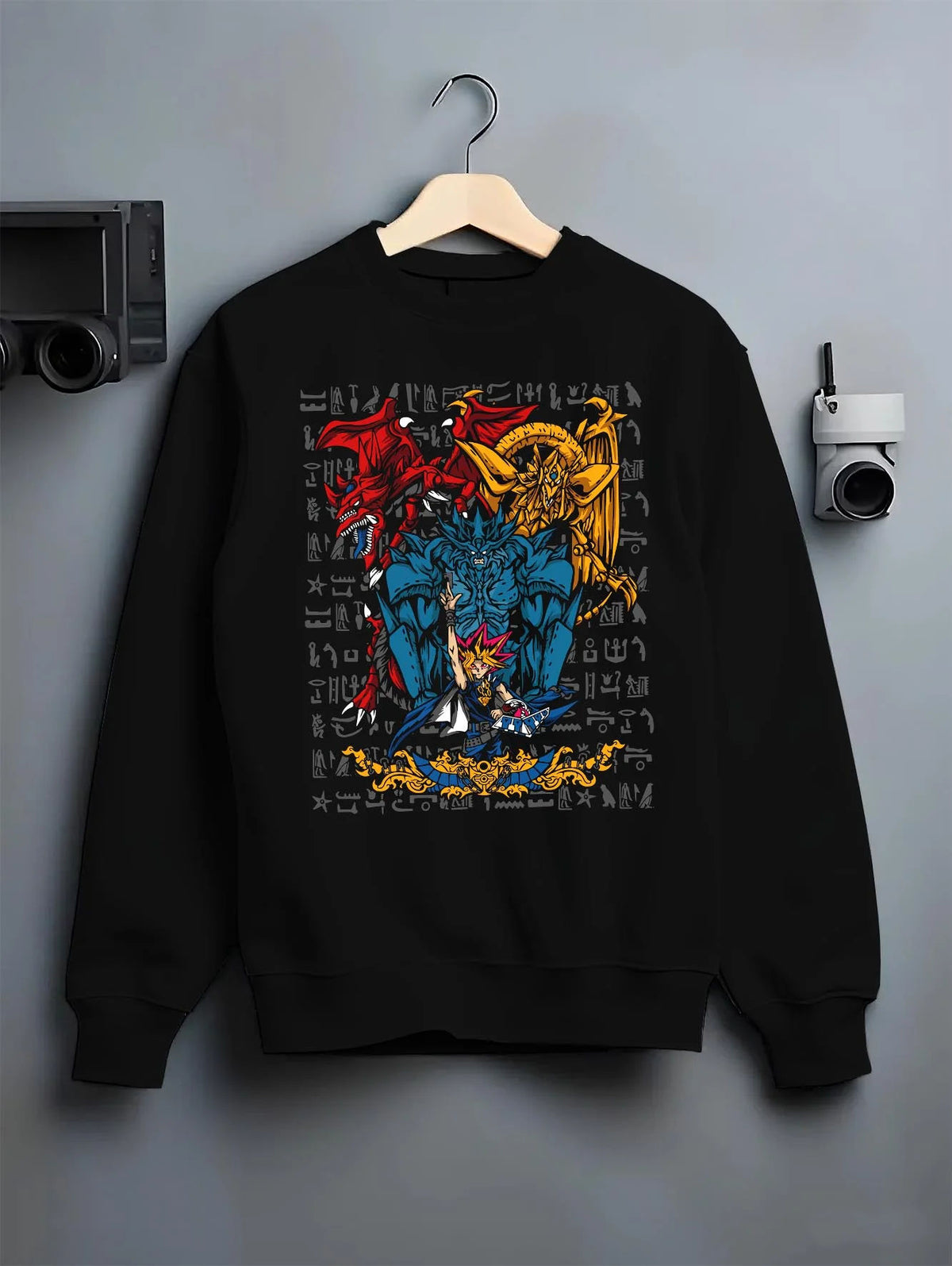 Black crewneck sweatshirt on hanger featuring Yugi with the Egyptian Gods Yu-Gi-Oh! artwork.