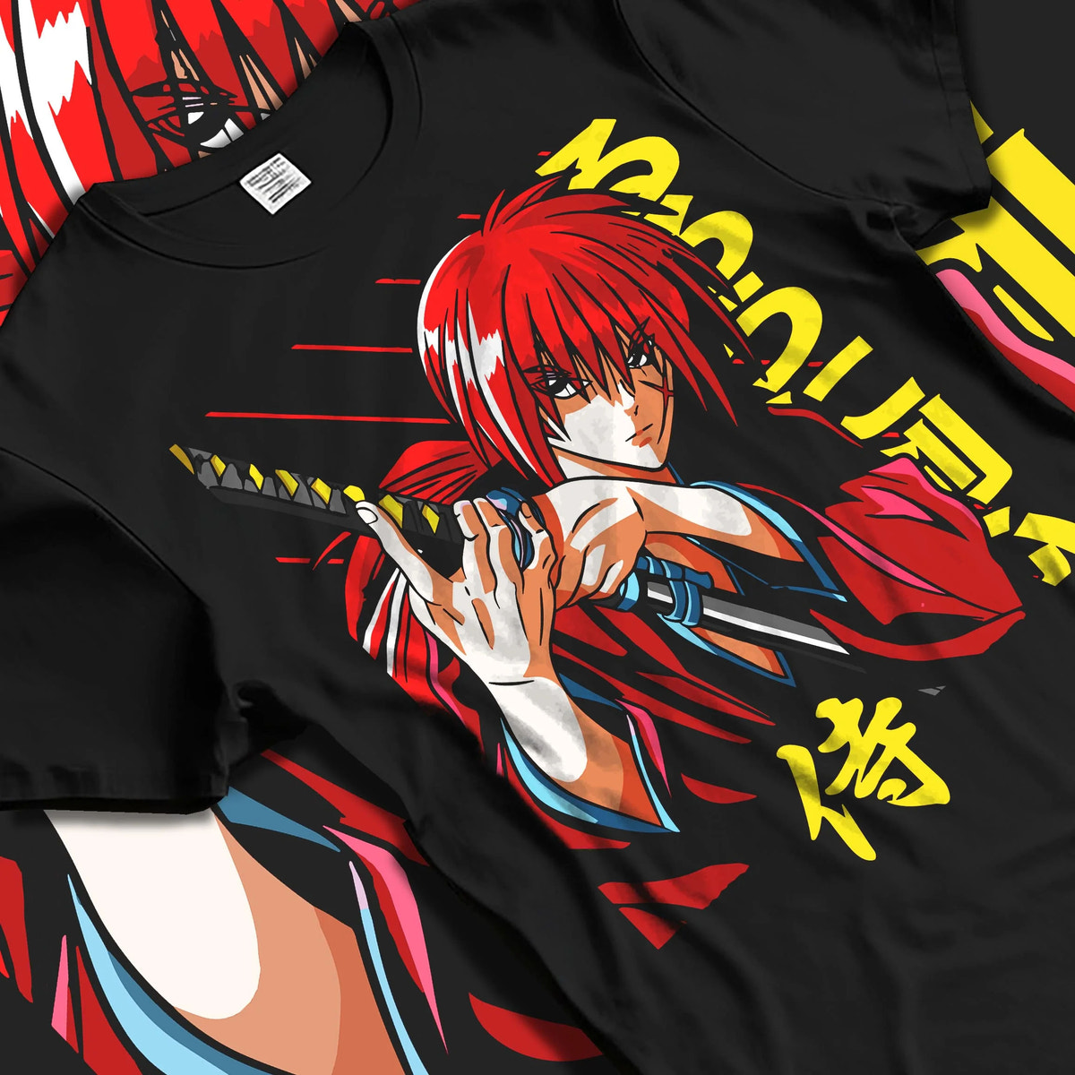 Black T-shirt laid flat with natural folds featuring Kenshin Himura samurai sword Rurouni Kenshin artwork.