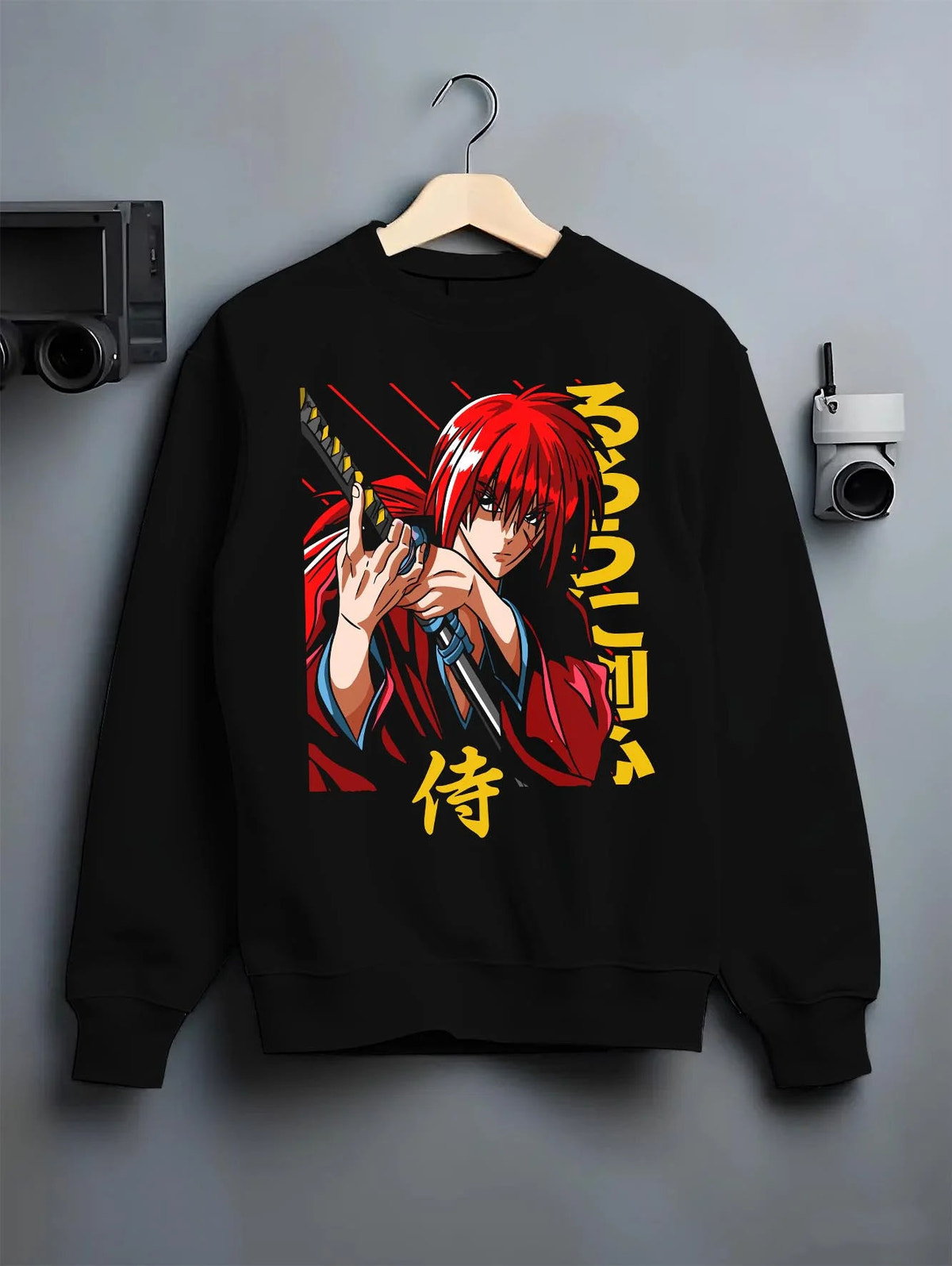 Black crewneck sweatshirt on hanger featuring Kenshin Himura samurai sword Rurouni Kenshin artwork.