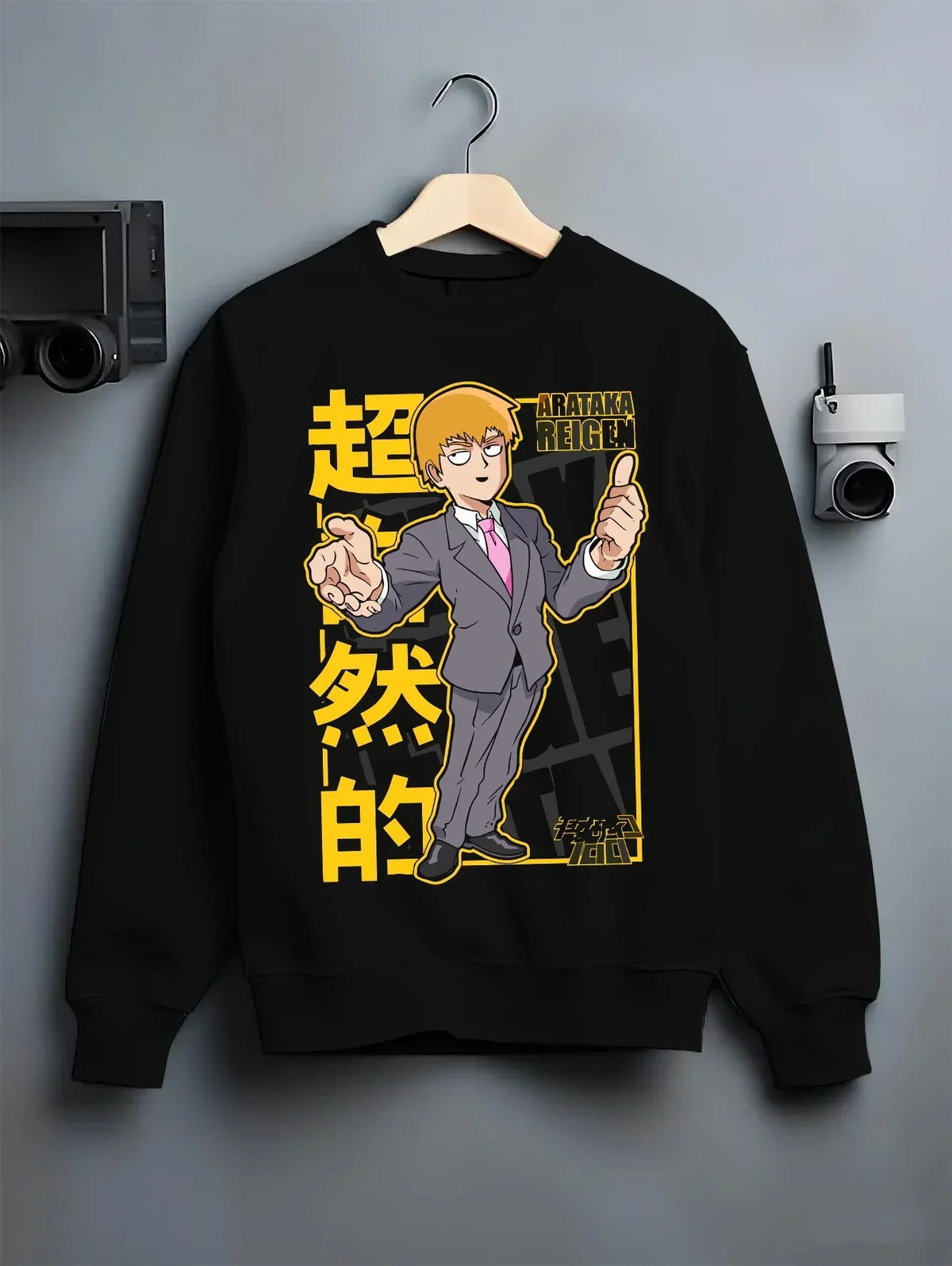 Black crewneck sweatshirt on hanger with Reigen Hoodie Mob Psycho 100 Master of Exorcism graphic premium wear.