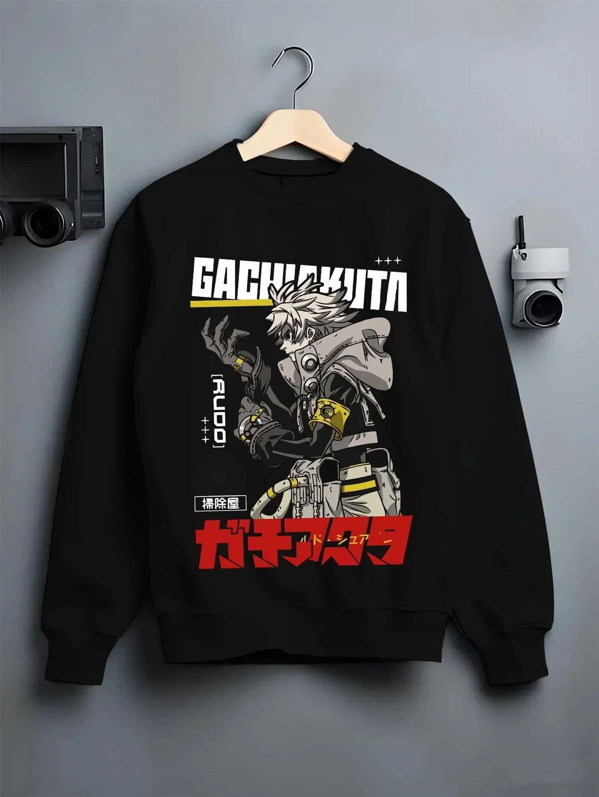 Black crewneck sweatshirt on hanger with Rudo Hoodie Gachiakuta Combat Jacket Edition graphic premium wear.