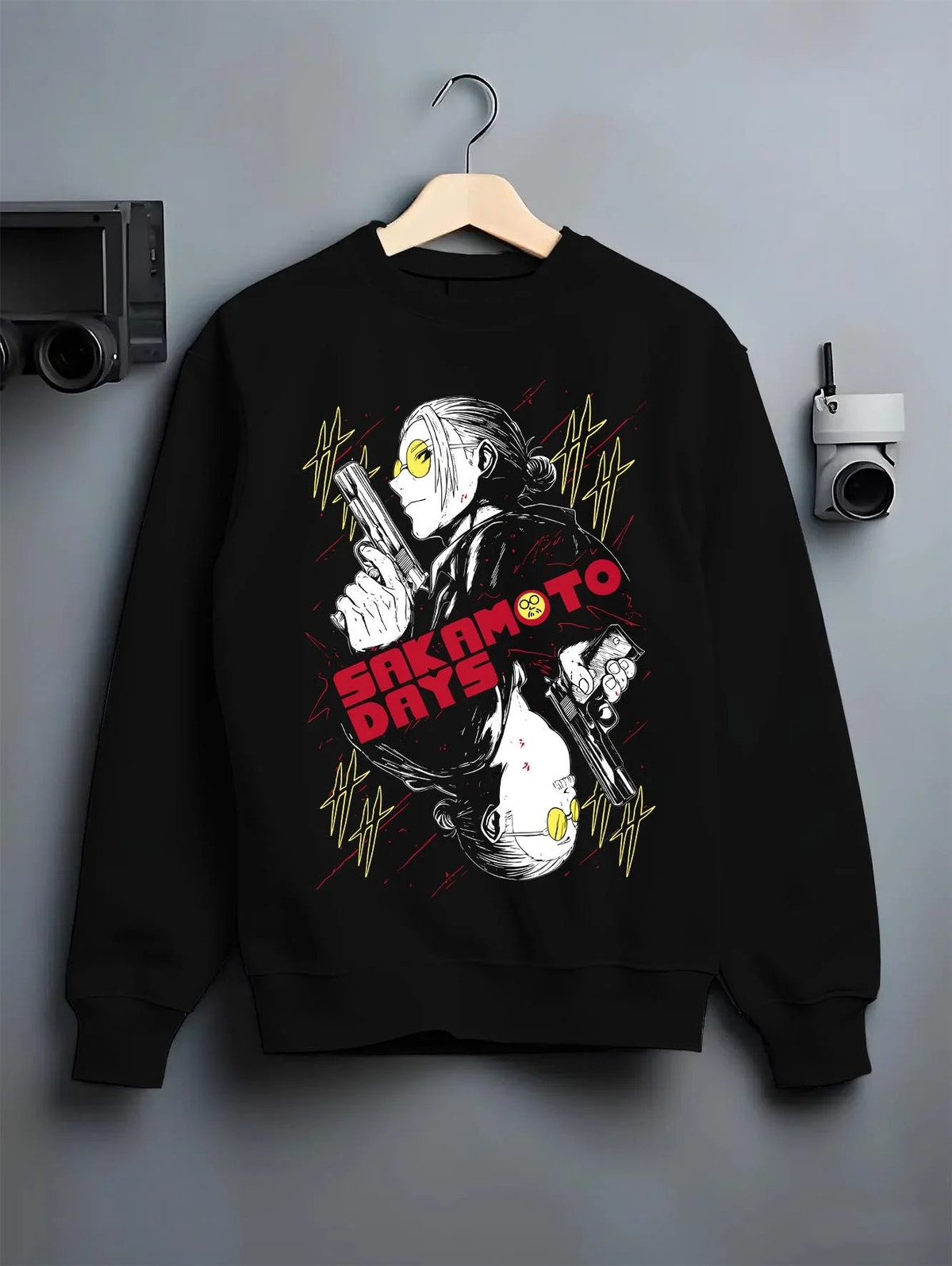 Black crewneck sweatshirt on hanger featuring Sakamoto Days elite assassin gunfight artwork.