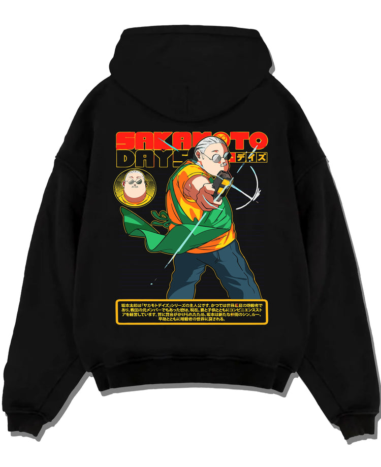 Black hoodie laid flat featuring Taro Sakamoto assassin battle Sakamoto Days artwork.