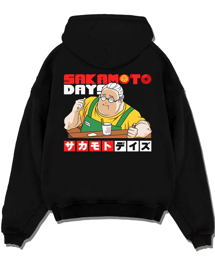 Black hoodie laid flat featuring Taro Sakamoto golden lion graphic Sakamoto Days artwork.