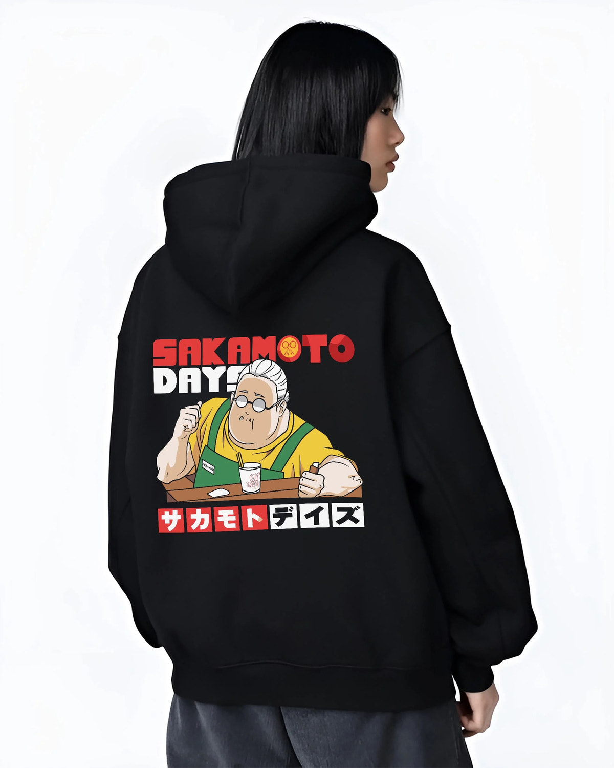 Black hoodie worn by female model from the back featuring Taro Sakamoto golden lion graphic Sakamoto Days artwork.