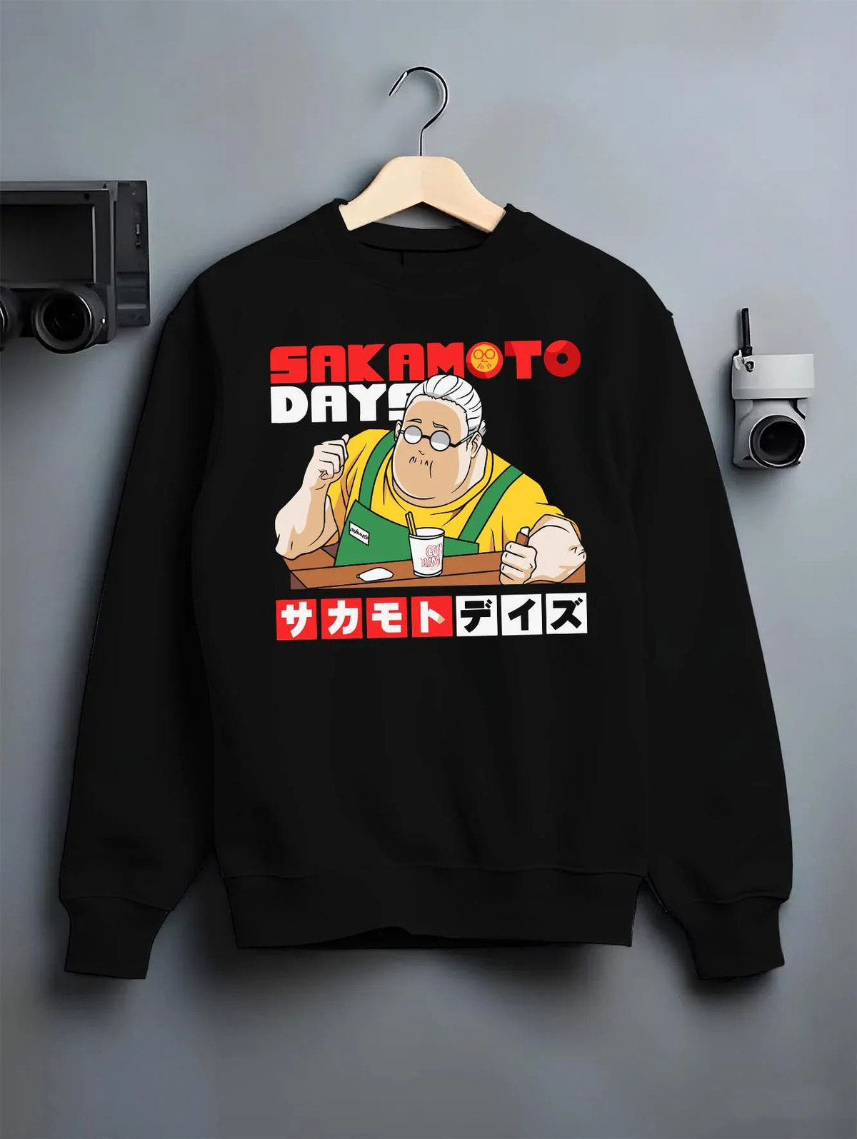 Black crewneck sweatshirt on hanger featuring Taro Sakamoto golden lion graphic Sakamoto Days artwork.