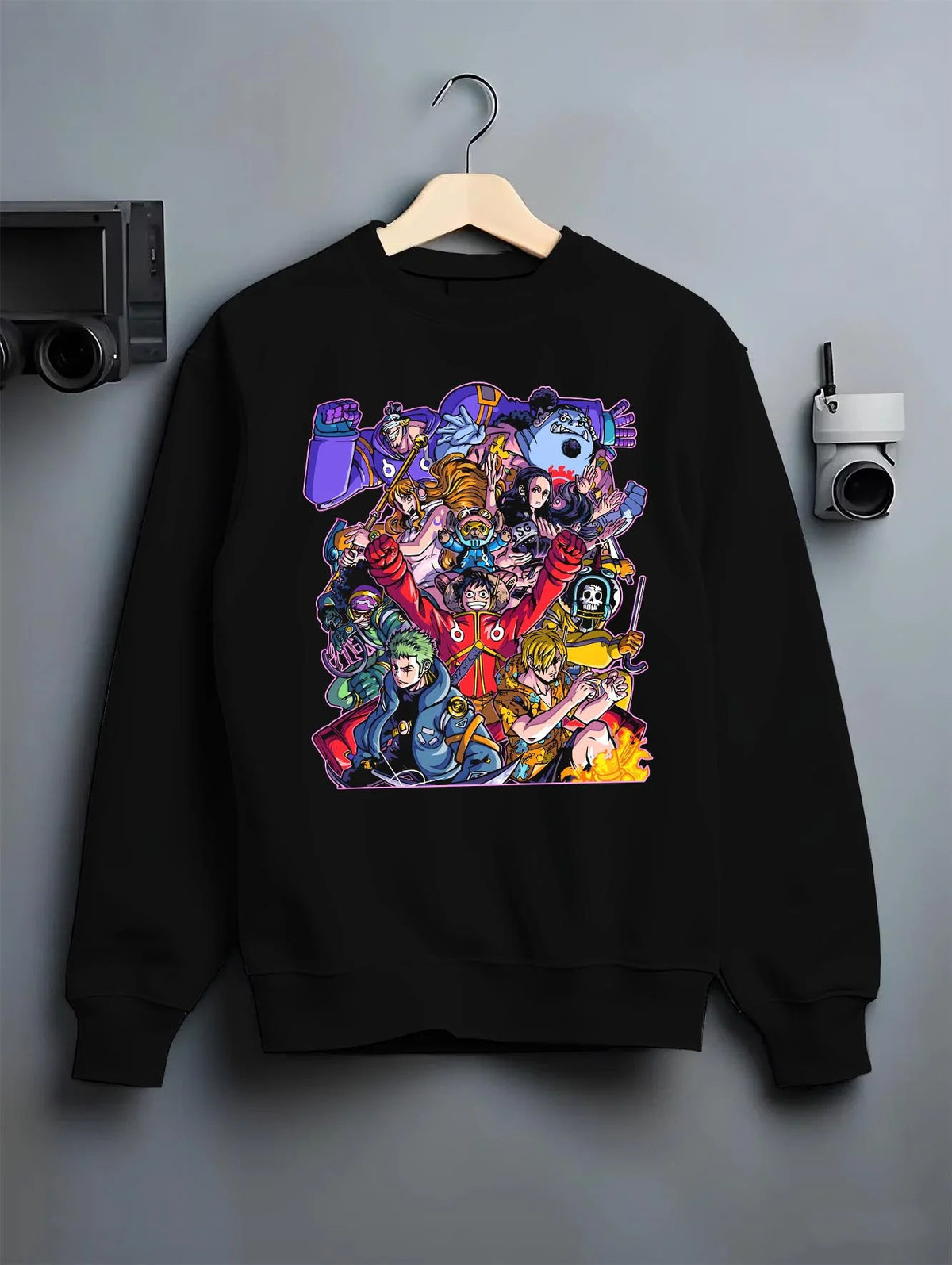 Black crewneck sweatshirt on hanger featuring Straw Hat Crew pirate team adventure One Piece artwork.