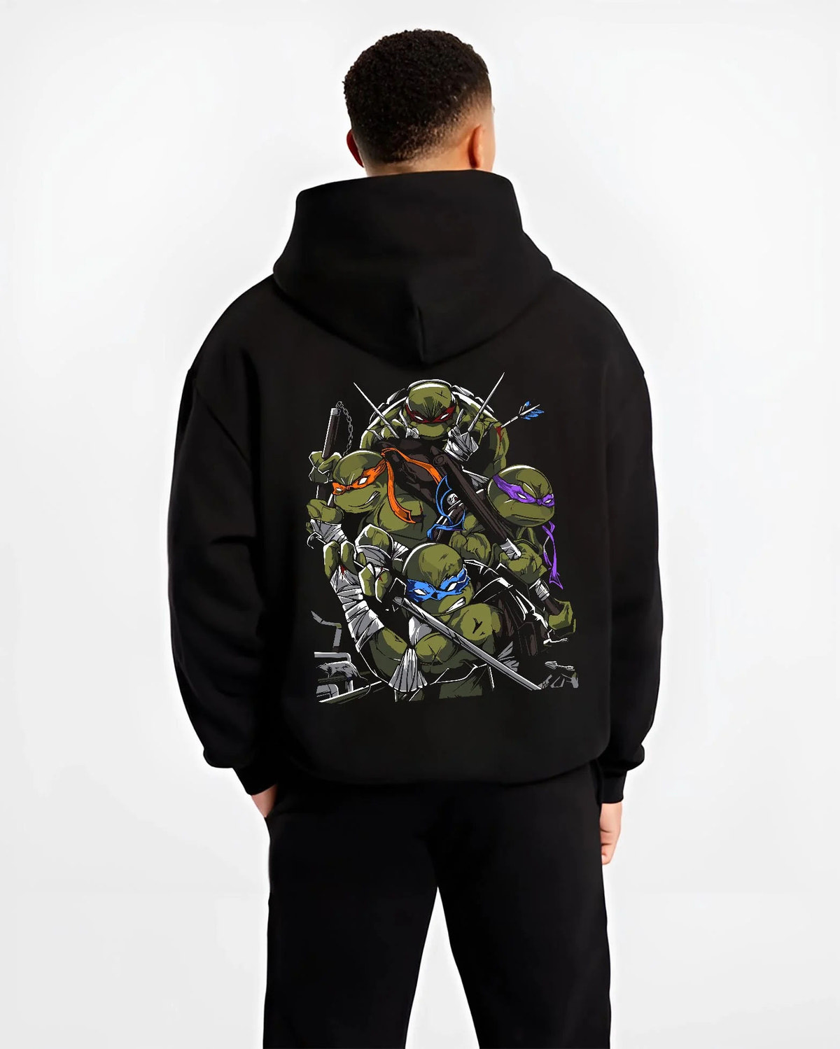 Black hoodie worn by male model from the back featuring Teenage Mutant Ninja Turtles sewer team TMNT artwork.