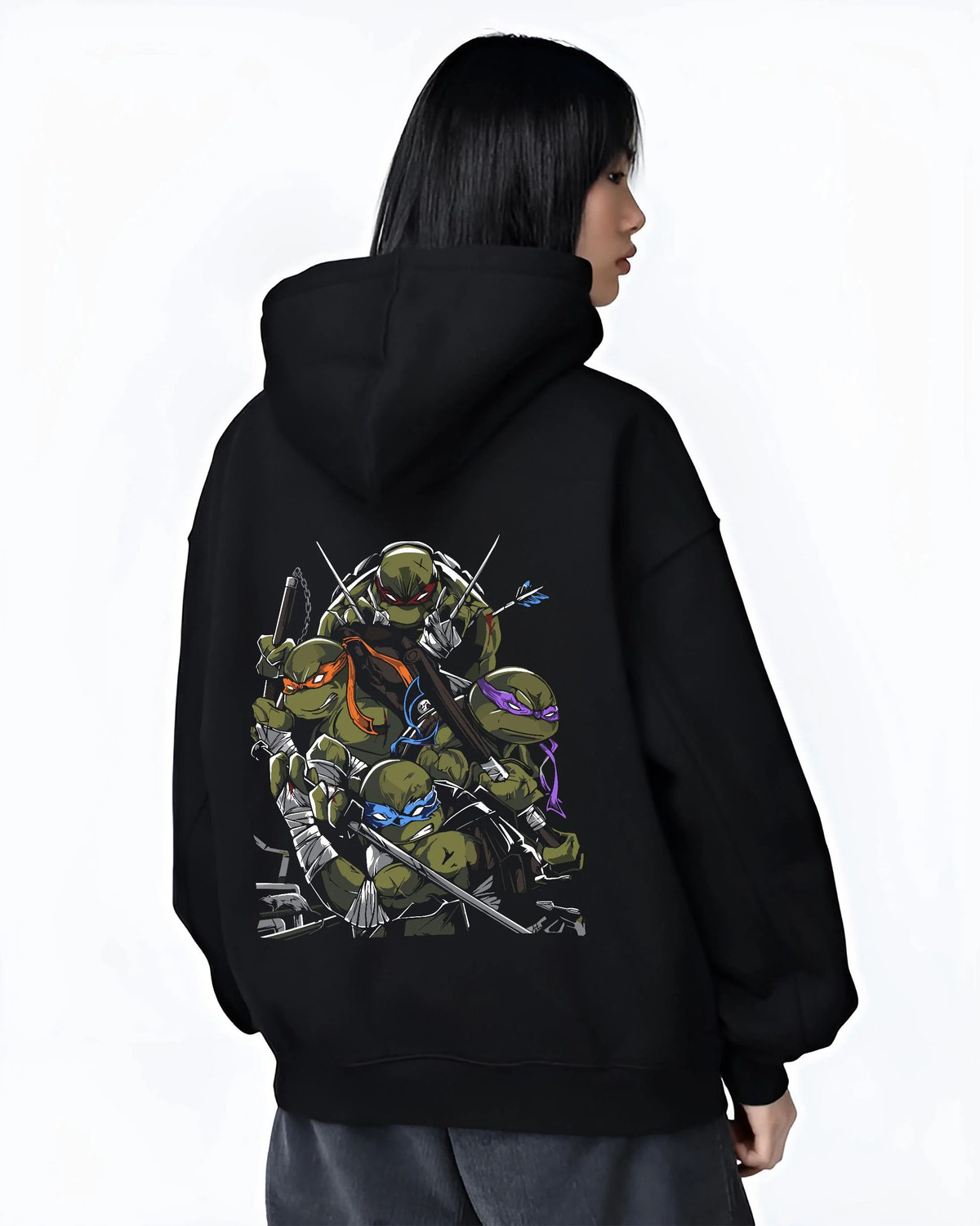 Black hoodie worn by female model from the back featuring Teenage Mutant Ninja Turtles sewer team TMNT artwork.