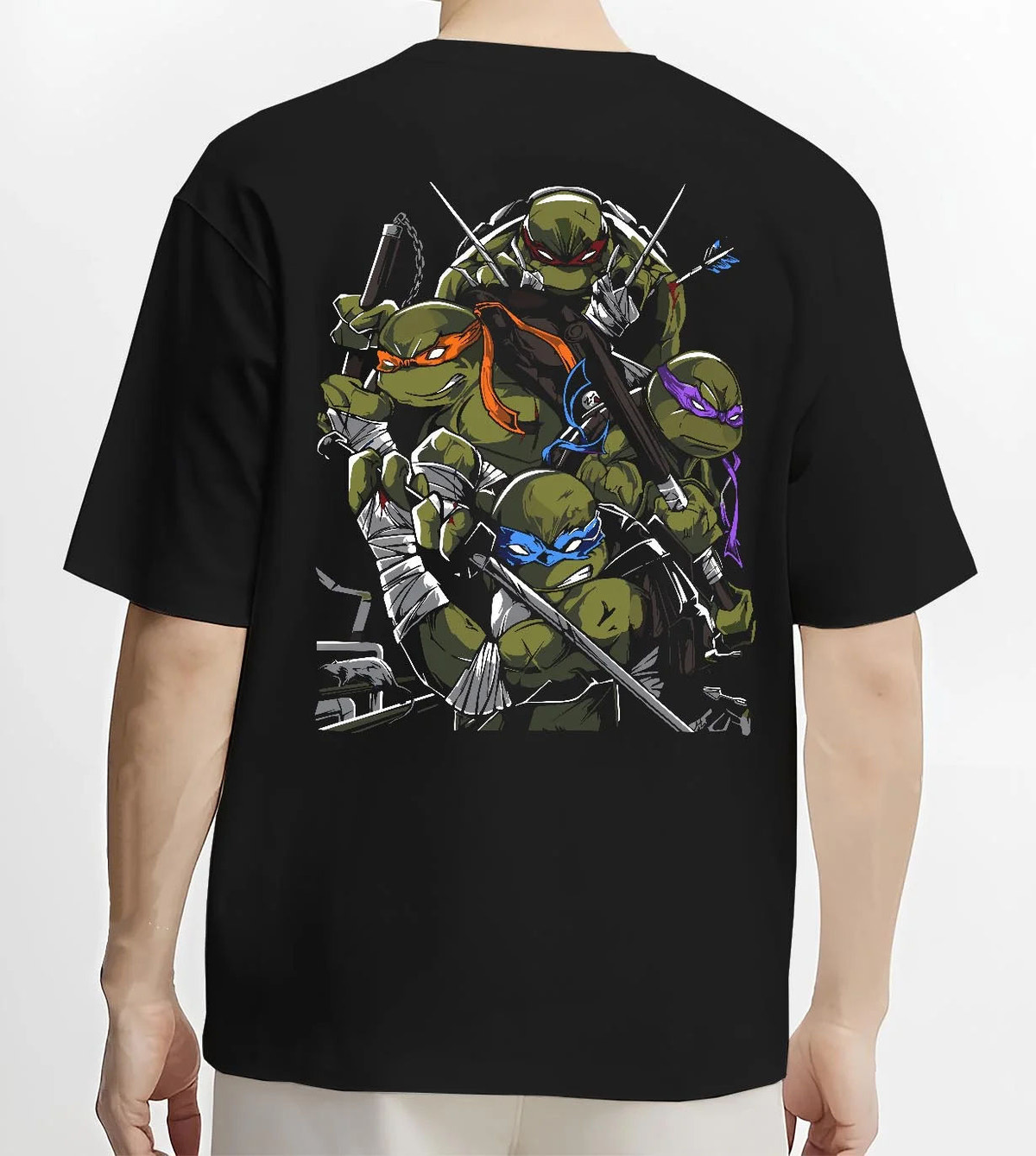 Black T-shirt worn by male model from the back featuring Teenage Mutant Ninja Turtles sewer team TMNT artwork.