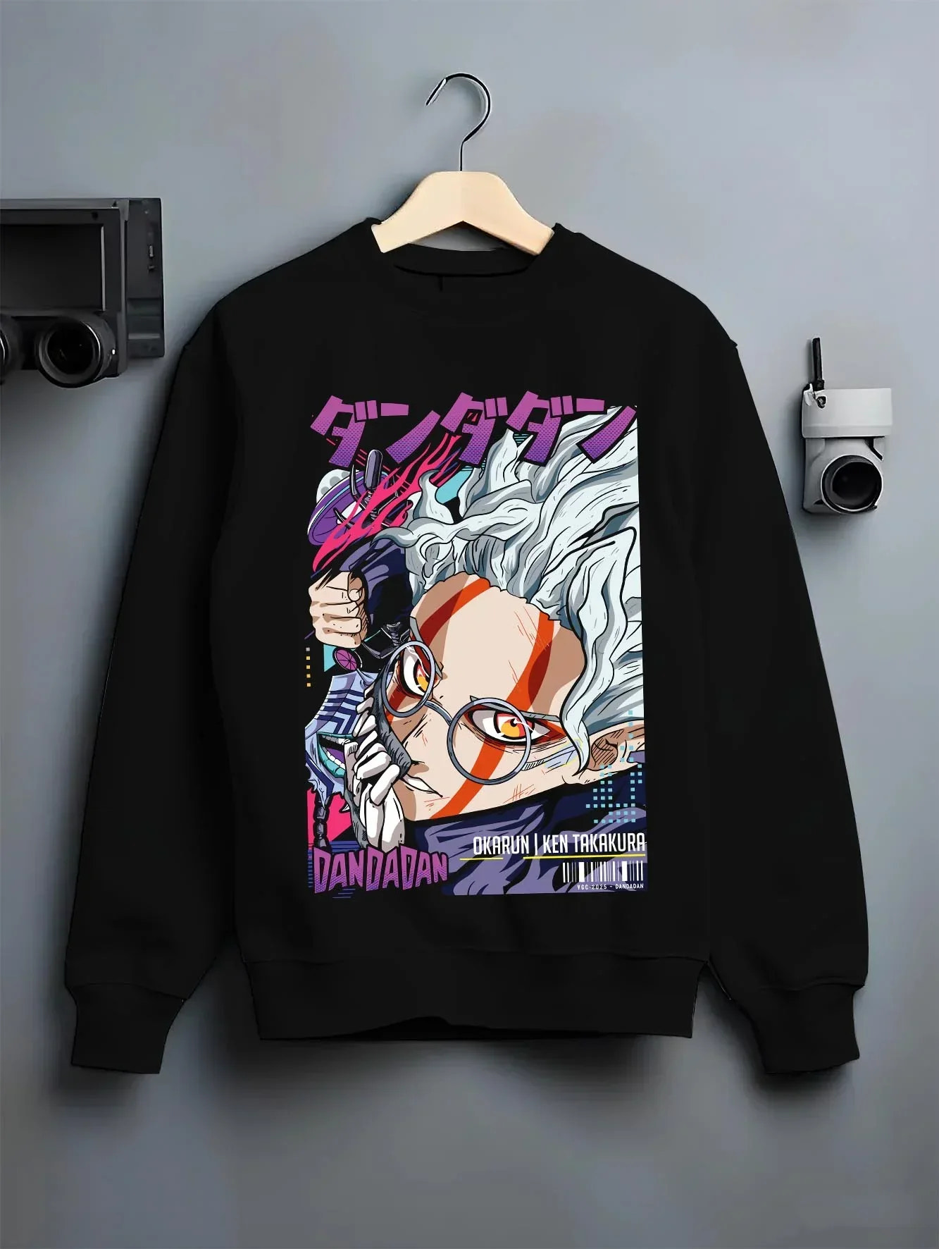Black crewneck sweatshirt on hanger with Ken Takakura Hoodie Dandadan Dynamic Fight Scene graphic streetwear graphic.
