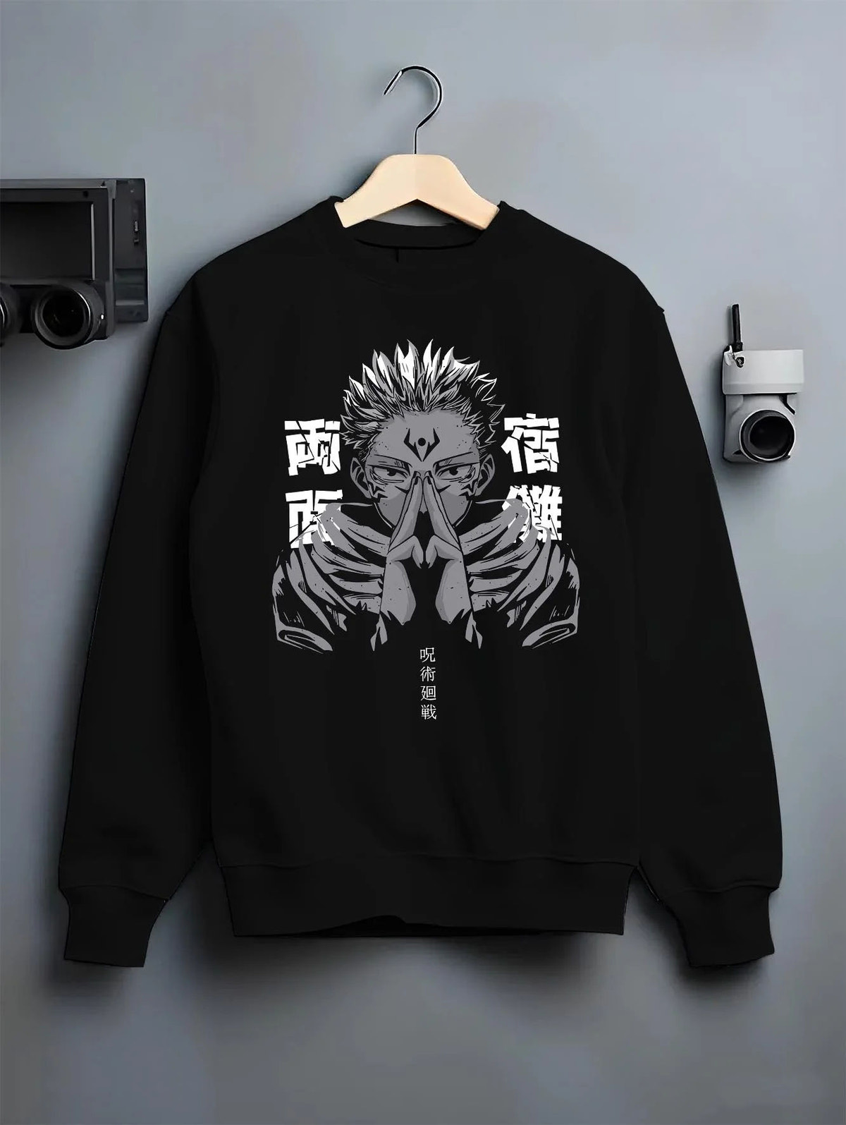 Black crewneck sweatshirt on hanger featuring Ryomen Sukuna domain hand sign Jujutsu Kaisen artwork.