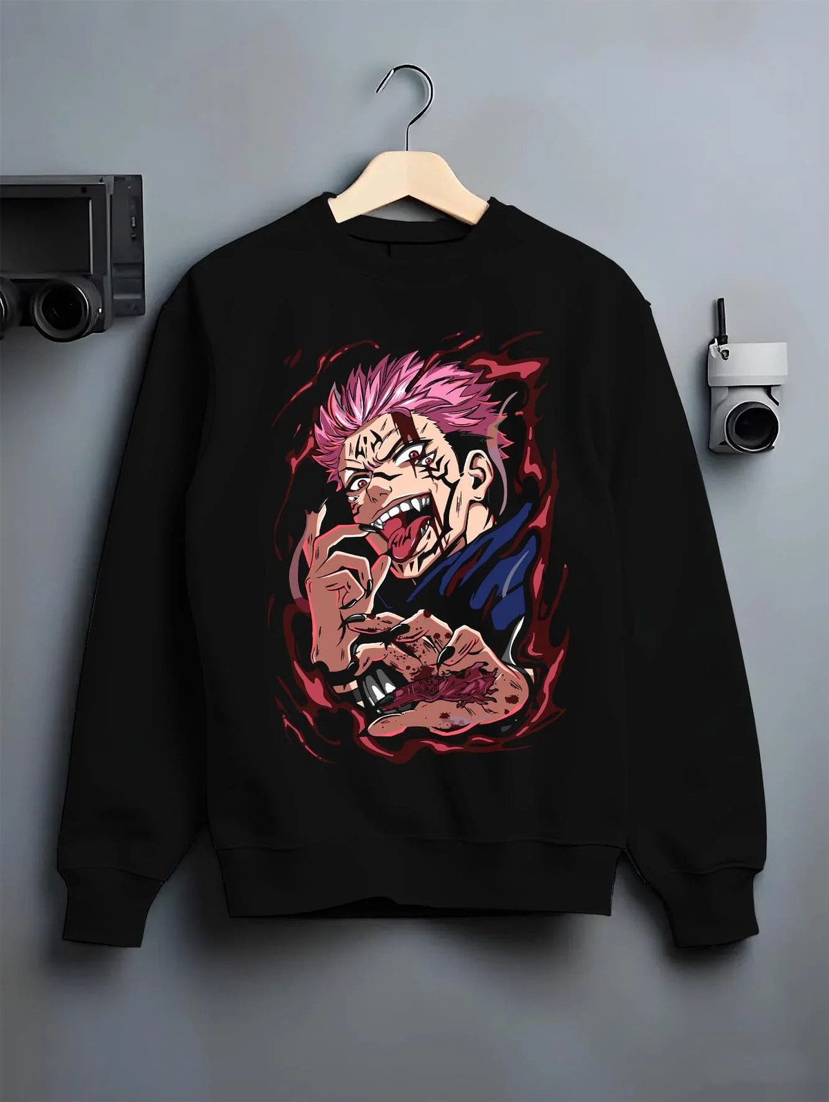 Black crewneck sweatshirt on hanger featuring Ryomen Sukuna red cursed energy Jujutsu Kaisen artwork.