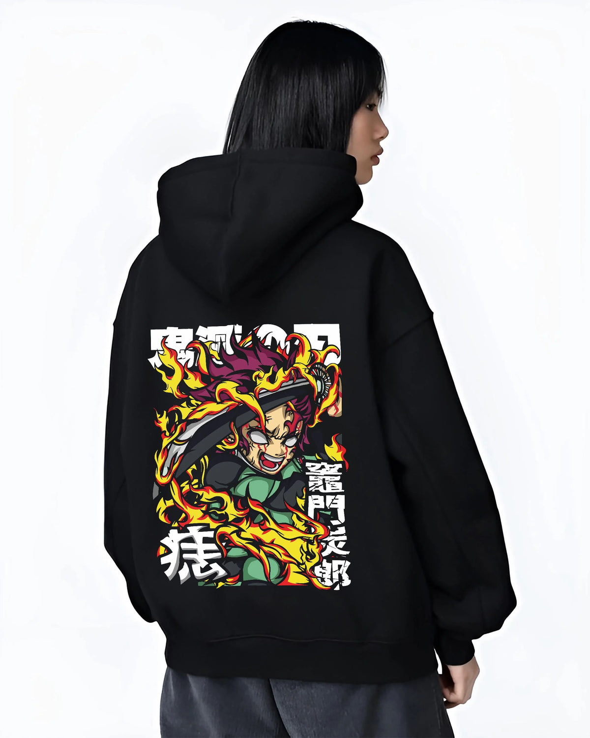 Black hoodie worn by female model from the back featuring Yoriichi Tsugikuni Sun Breathing flame aura Demon Slayer artwork.