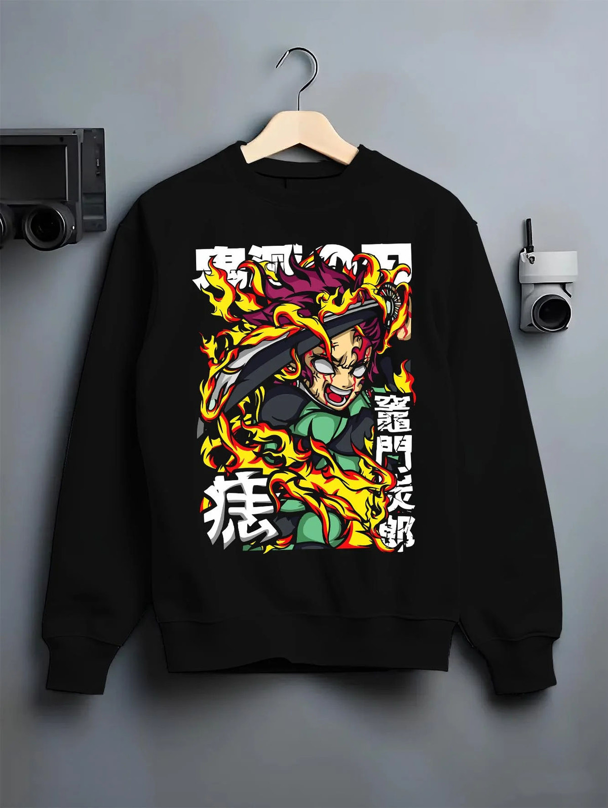 Black crewneck sweatshirt on hanger featuring Yoriichi Tsugikuni Sun Breathing flame aura Demon Slayer artwork.
