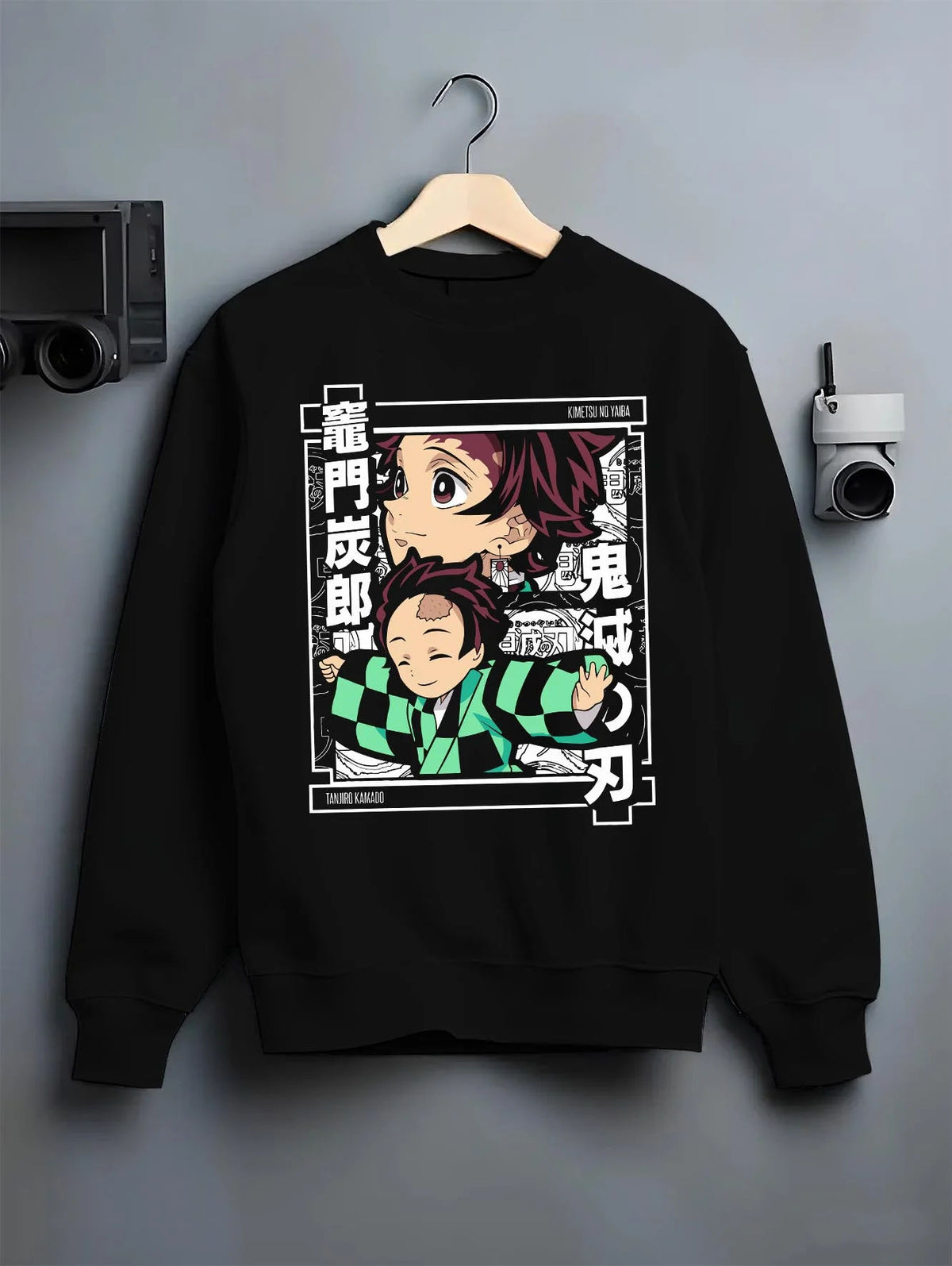 Black crewneck sweatshirt on hanger featuring Tanjiro Kamado chibi family Demon Slayer artwork.