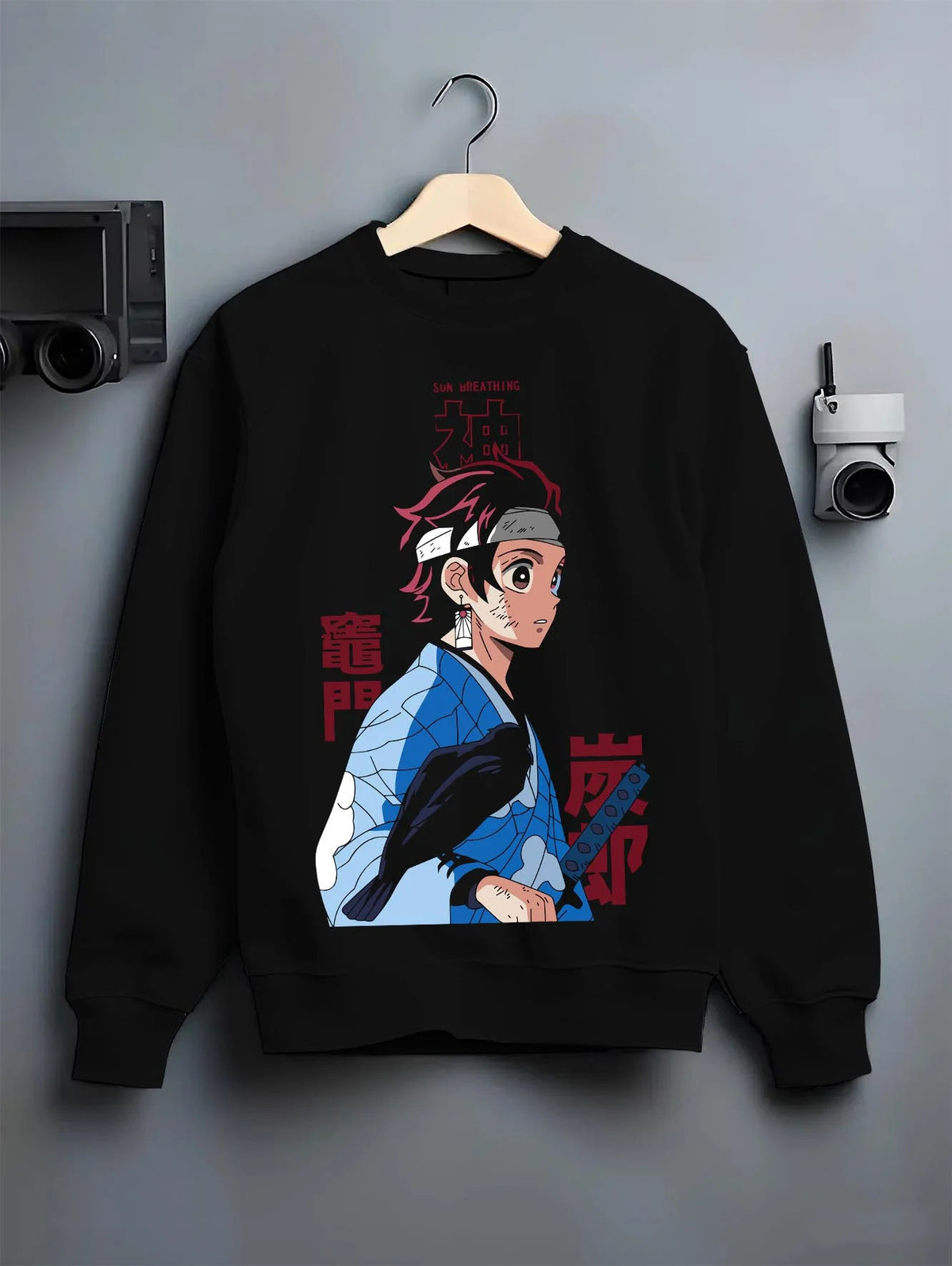 Black crewneck sweatshirt on hanger featuring Tanjiro Kamado Demon Slayer Mark artwork.