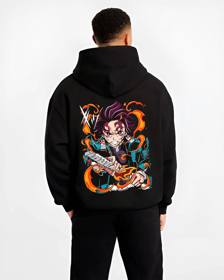 Black hoodie worn by male model from the back featuring Tanjiro Kamado Hinokami Kagura flame sword Demon Slayer artwork.